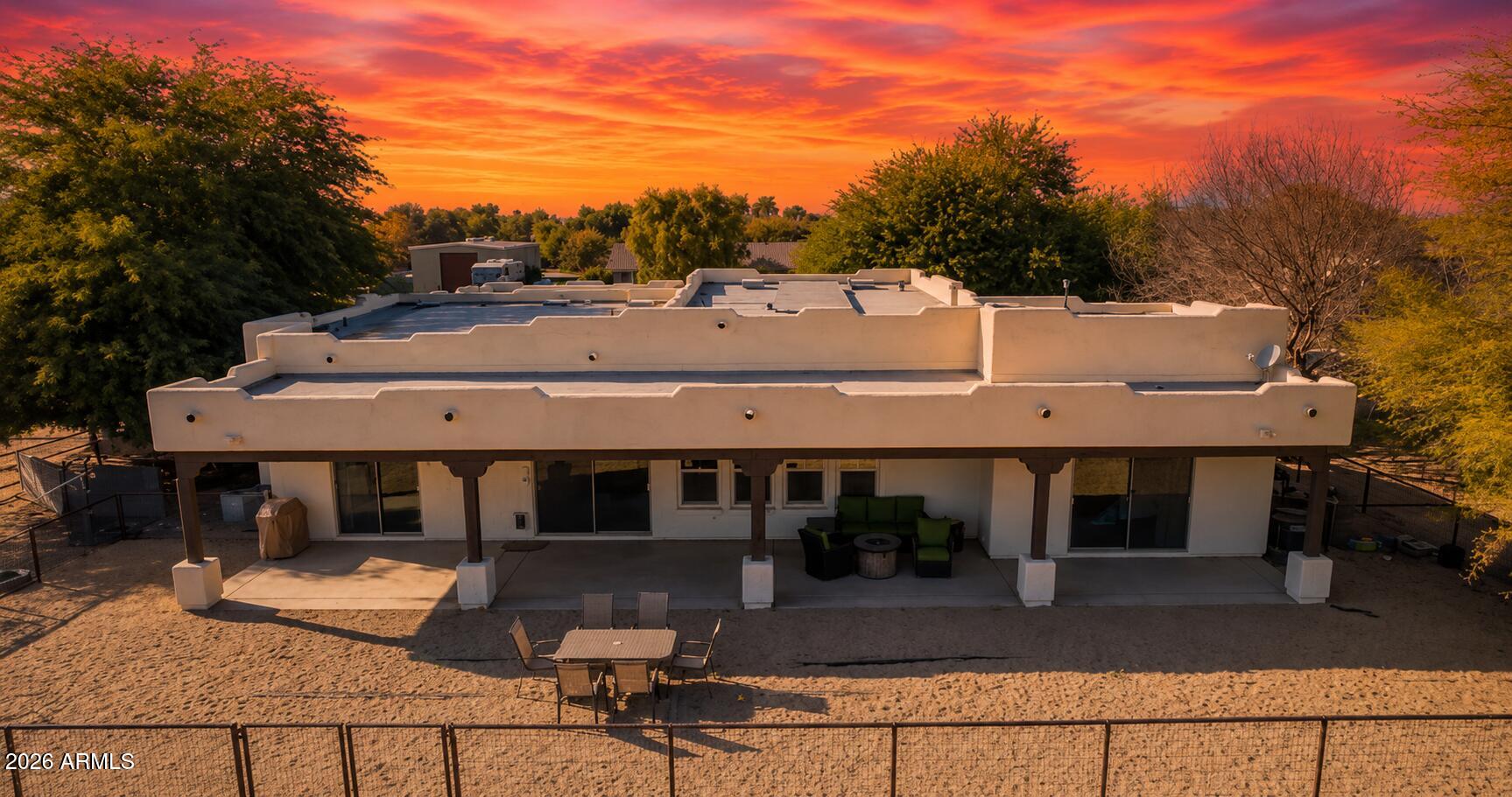OWNED SOLAR | 1 ACRE IRRIGATED HORSE PROPERTY | 6 STALLS + 145'x145' ARENA | NO HOA

Who wants to own a 'lil' YELLOWSTONE ranch in Arizona? 
Whether you're throwing a loop all day at steers or doing western pleasure riding this, lil ranch is the perfect fit! Like a good pair of Wrangler jeans!

Built for the equestrian lifestyle, this fully irrigated 1-acre property combines a custom 2,806 sq ft Santa Fe-style home with infrastructure that is difficult to replicate. The setup includes six permanent horse stalls constructed with pipe, a hay barn and tack room, and a raked, de-stoned arena ready for daily riding, training, or roping practice. With a true SOUTHWEST design, exposed vigas, 12-foot ceilings, and a spacious great room create an open layout designed for everyday living. The kitchen flows seamlessly into the family room with fireplace and adjacent dining area, keeping everyone connected. A dedicated office and optional fourth bedroom provide flexibility for work, guests, or hobbies. The owner's suite offers a soaking tub, walk-in shower, and oversized walk-in closet, while the secondary bedrooms are connected by a Jack-and-Jill bath. Flood irrigation in both the front and back supports the property's green landscape and rural functionality. A three-car garage adds ample space for vehicles, trailers, equipment, and storage. Conveniently located near the Buckeye Equestrian Center, approximately 45 minutes from Wickenburg, the "Roping Capital of the World", with easy access to major highways, shopping, schools, and everyday amenities.