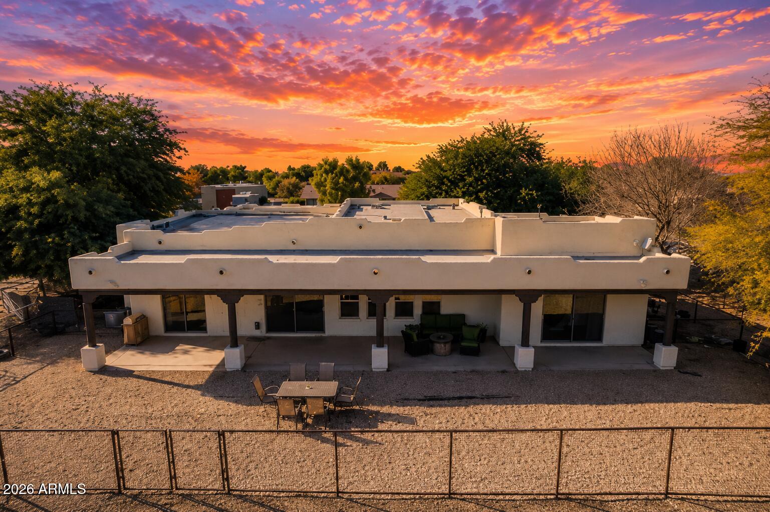 OWNED SOLAR | 1 ACRE IRRIGATED HORSE PROPERTY | 6 STALLS + 145'x145' ARENA | NO HOA

Who wants to own a 'lil' YELLOWSTONE ranch in Arizona? 
Whether you're throwing a loop all day at steers or doing western pleasure riding this, lil ranch is the perfect fit! Like a good pair of Wrangler jeans!

Built for the equestrian lifestyle, this fully irrigated 1-acre property combines a custom 2,806 sq ft Santa Fe-style home with infrastructure that is difficult to replicate. The setup includes six permanent horse stalls constructed with pipe, a hay barn and tack room, and a raked, de-stoned arena ready for daily riding, training, or roping practice. With a true SOUTHWEST design, exposed vigas, 12-foot ceilings, and a spacious great room create an open layout designed for everyday living. The kitchen flows seamlessly into the family room with fireplace and adjacent dining area, keeping everyone connected. A dedicated office and optional fourth bedroom provide flexibility for work, guests, or hobbies. The owner's suite offers a soaking tub, walk-in shower, and oversized walk-in closet, while the secondary bedrooms are connected by a Jack-and-Jill bath. Flood irrigation in both the front and back supports the property's green landscape and rural functionality. A three-car garage adds ample space for vehicles, trailers, equipment, and storage. Conveniently located near the Buckeye Equestrian Center, approximately 45 minutes from Wickenburg, the "Roping Capital of the World", with easy access to major highways, shopping, schools, and everyday amenities.