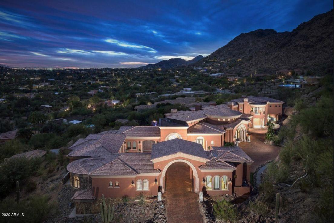 Certainly one of Paradise Valley's most thoughtfully designed, impeccably appointed & masterfully built estates! Privately gated & nestled on Mummy Mountain this estate overlooks the entire valley with unobstructed, breathtaking city lights & mountain views! This remarkable luxury custom estate with an unrivaled sophistication of finishes & attention to detail remains true to its timeless architecture. Highlights of this estate are: 9 bedrooms, 10.5 bathrooms, home theater, gym, 1,400 SF guest house, a true resort style backyard with multiple pools, negative edge waterfall, water slide & spa, interior basketball court, covered patio & built-in BBQ. The architectural details & finishes of this home create a timeless estate with the ultimate in casual elegance. Watch our motion video!