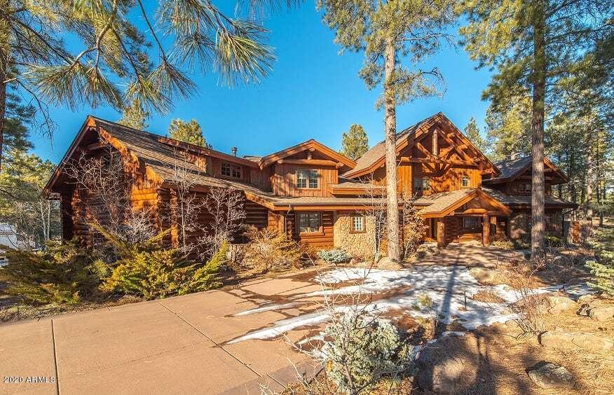 This breathtaking legacy home is exuding with luxurious details throughout.
 A perfect combination of log and beauty radiates an elegant rustic flair in this immaculate 6,453 Square Foot home while the panoramic views of the San Francisco Peaks, golf course and tall ponderosa trees offer immense peace and tranquility the moment you walk through the door. 
This handcrafted custom home is perfectly situated on 1.43 Acres of tall pines with stunning fairway and mountain views. Meticulously crafted with Rocky Mountain Logs and designed by Kibo Architecture this amazing property features a modern, open concept with beautiful details throughout.  Everything about this home is stunning! The spacious great room is magnified with a wall of windows and the most amazing picturesque views of the San Francisco Peaks. There is a floor to ceiling rock fireplace with an intimate second fireplace seating area. The main floor master suite is an oasis in itself with a sitting area, fireplace and luxurious master bath that has been completely renovated. There is also a large walk in custom closet featuring extensive built-ins and an entire spacious loft with a private deck that makes the master suite one of a kind.
The Chef's kitchen and entertaining area offer beautiful cabinetry, custom granite counters, and top of the line new appliances, a spacious walk in pantry, custom lighting, entertainment bar, breakfast room plus a formal dining area all with stunning views. From the kitchen there is a covered patio with a brand new Wolfe BBQ Grill, prep sink area and an amazing fire pit. This home is an entertainers dream both inside and out!
There are 3 en-suite guest rooms on the main floor and two huge kids bunk rooms on the upper level, there is room for all your family and friends to enjoy the best of Northern Arizona. Adjacent to the kids bunk rooms you will find a fantastic game room, spacious enough to fit all the toys your family enjoys. Also on the upper level, you will be impressed with the second game room/loft area featuring another gorgeous fireplace and game table.
The home totals 6 bedrooms, 6.5 baths, 4 fireplaces, extensive outdoor living space with firepit and a 4 car garage.
This Forest Highlands masterpiece must be seen to appreciate the quality and attention to every single detail. This is the perfect property for the multi-generational family, multiple families, corporate retreat or your own private paradise.