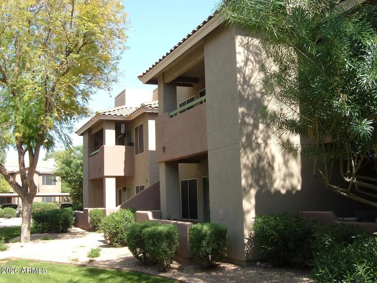 Discover this beautifully updated one-bedroom, one-bath condo offering the perfect blend of comfort, style, and unbeatable location. Featuring neutral paint and plush carpeting with tile, a cozy fireplace in the living room, and a fully equipped kitchen with refrigerator, range, dishwasher, and built-in microwave. Enjoy the convenience of in-unit washer and dryer. Step outside to resort-style living with three oasis-style pools and spas, lush greenbelts filled with mature trees, and serene landscaping. The community boasts a spacious elegant clubhouse, gym, and tennis courts--truly a private retreat. Ideally situated near hospitals, world-class shopping, dining, and entertainment, with easy access to Loop 101. Covered parking #E2 included. water, sewer, trash, covered by HOA