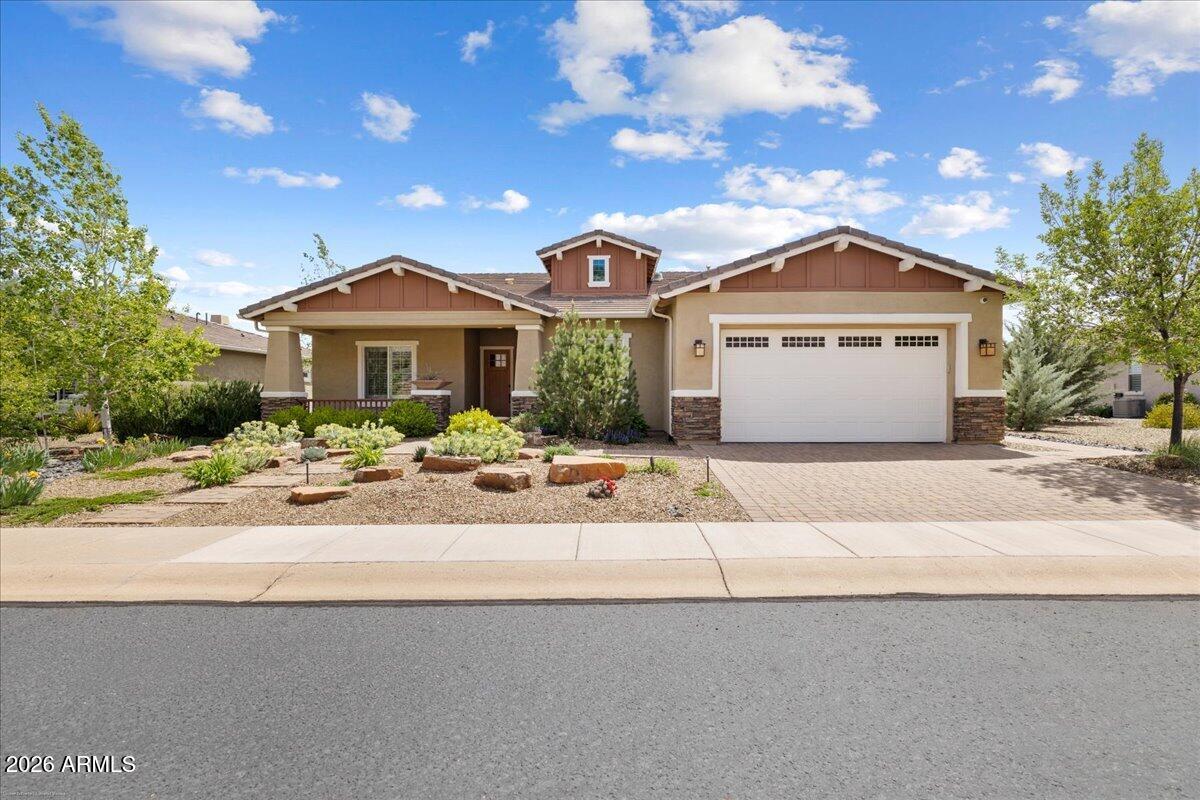 This isn't just a home--it's a lifestyle. Set right on the 8th fairway at the desirable Prescott Lakes golf course, this well appointed and highly upgraded 2,572 square feet home has stunning views and all main level living. If you're looking for more space, you can also enjoy the separate/additional 1,400 square feet bonus space.  With its own private lower-level entrance, you will enjoy ''The Barn.'' The barn is a western-inspired game and hobby space designed for entertaining, complete with a bar, kitchenette, mini-split system, game areas, tons of hidden storage and its own patio overlooking the golf course. It's truly one of a kind--and yes, all personal property in the barn does convey. The main level includes 3 bedrooms, 3 bathrooms, a den/office, and a 3-car tandem garage with epoxy floors. The great room is open and inviting, centered around a stone fireplace, and flows into a gourmet kitchen with GE Café appliances, leathered granite counters, a walk-in pantry, and a formal dining area. Step out onto the Trex deck and take in the incredible golf course and mountain views.The primary suite is tucked away for privacy and feels like a retreat, with a spa-style bathroom featuring a soaking tub, glass shower, dual vanities, and a large walk-in closet. You can enter the laundry room from the master closet. There's also a guest ensuite, an additional bedroom with a nearby full bath, and a flexible den/office space. From the moment you arrive, the home makes an impression with its stone accents, paver entry, and mature landscaping. Inside, you'll find thoughtful touches like plantation shutters, custom cabinetry, up-down shades, and a bright laundry room with plenty of storage and direct access to the garage.
Living in Prescott Lakes also means access to resort-style amenities, including an athletic center, pickleball, pools, hiking trails, fitness classes, dining, and the option for a private golf membership.