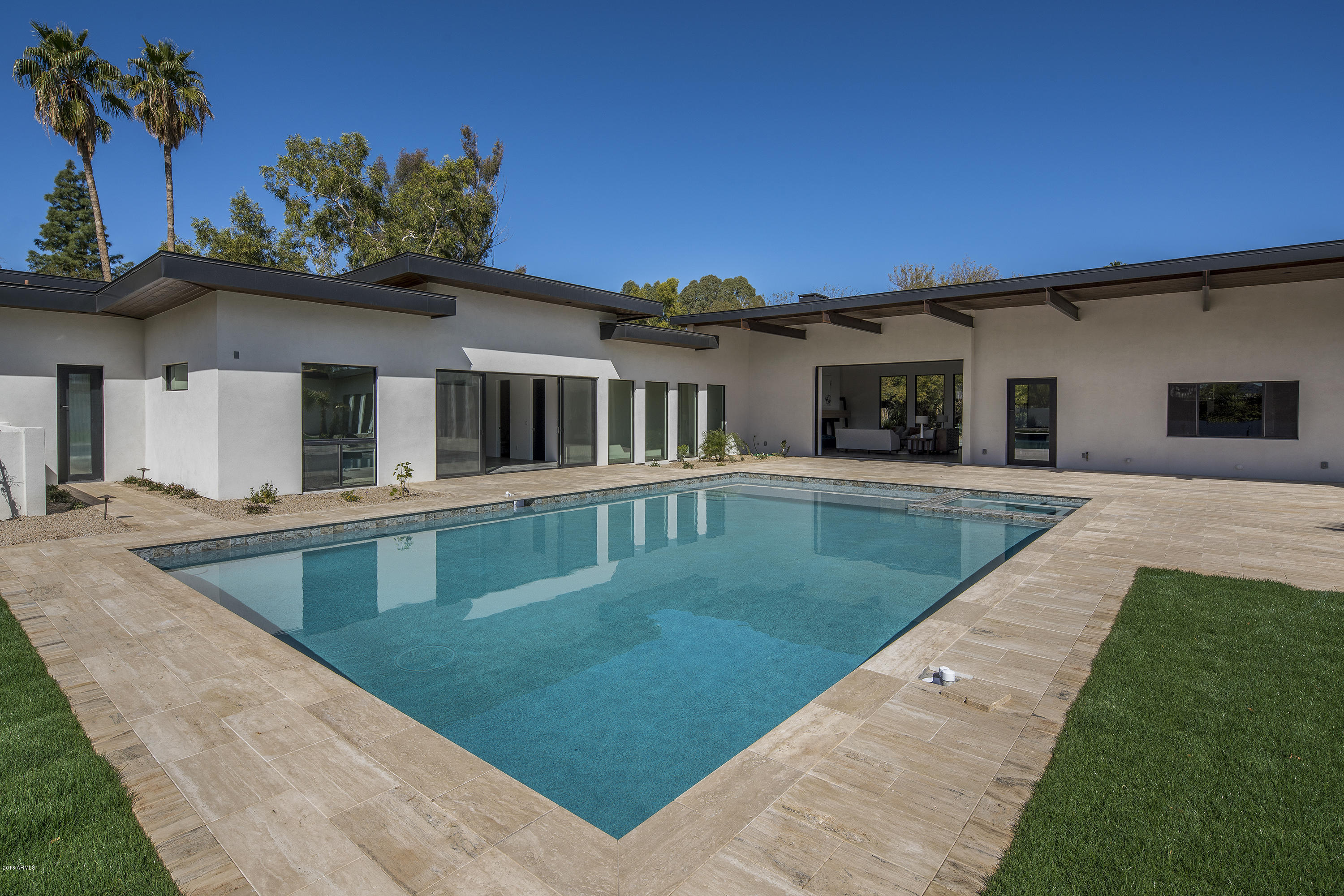 Just completed & pure perfection! This modern, contemporary estate is located in the heart of Paradise Valley. With a master suite, 4 guest bedrooms, 5 car garage, bonus room & stunning mountain views, what more could you ask for? The extensive master suite hosts a designer bathroom, two massive walk-in closets and two bonus rooms that would work perfectly as a gym & home office. Kitchen features an oversized quartz island, top of the line appliances and oversized wine refrigerator; perfect for entertaining. High quality finishes found throughout the home including porcelain tiles, custom cabinetry and top of the line light fixtures. The wall of telescoping doors in the family room make a seamless transition into the beautiful outdoor living space. This gorgeous estate will not last long!