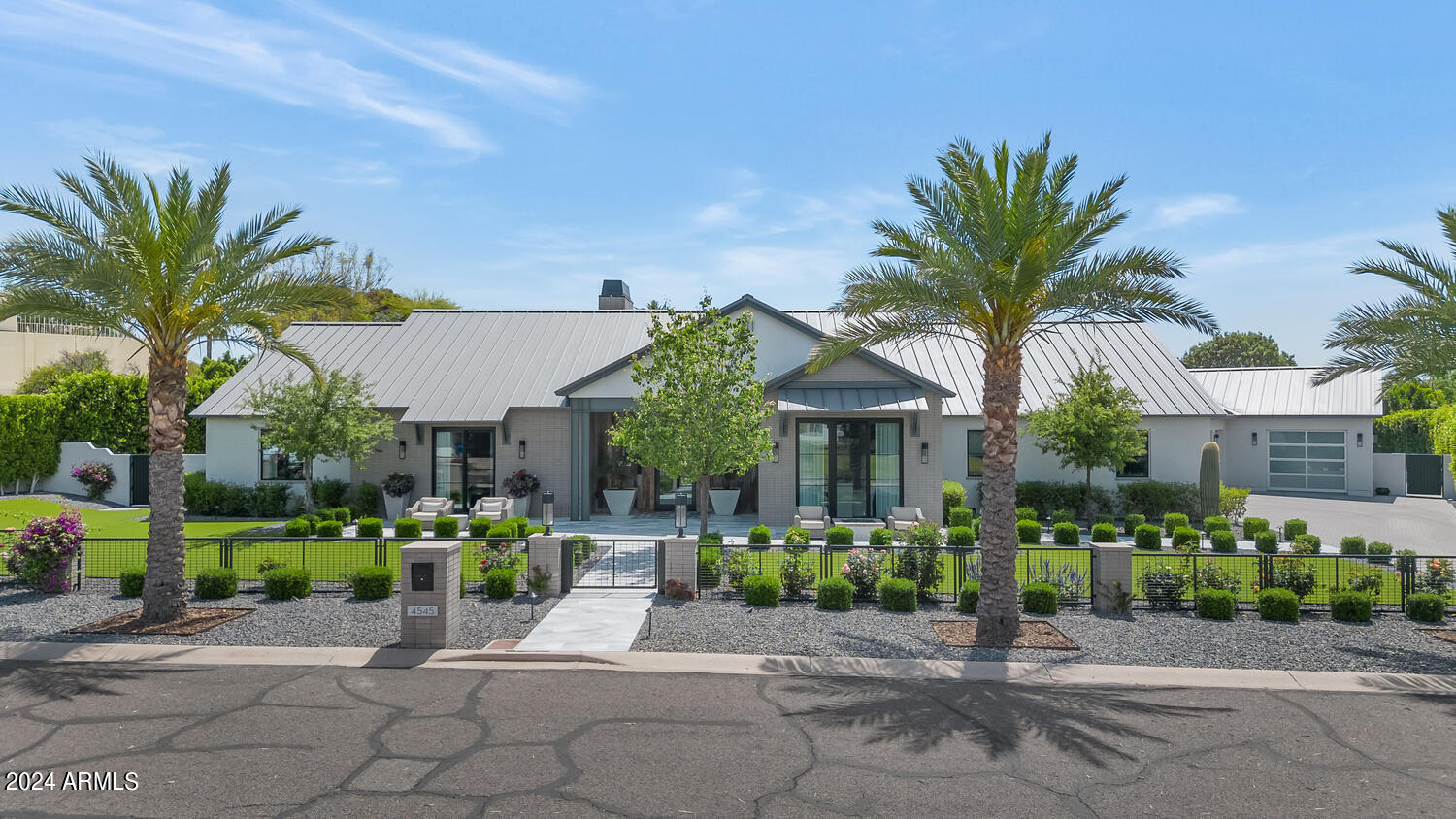 This home is absolutely exquisite and loaded with luxurious, up to the moment finishes. From the time you arrive, you'll be taken with the impressive curb appeal, and the lovely courtyard entry leads to a residence filled with modern elegance. The lavish great room is the focal point of the home featuring a floor to ceiling brick fireplace, soaring ceilings with wood beams, built-in back lit art niches, and retractable walls of glass that beautifully frame the backyard creating seamless indoor/outdoor living. The spectacular island kitchen has great looking custom cabinetry, top of the line appliances, tile accents, and more than enough room to prep and serve any number of guests who will enjoy both the formal and informal dining areas. All the bedrooms and baths are included a magnificent primary suite with its own fireplace, morning bar and luxurious bath, and the guest casita is filled with the same quality as the home. The grounds are phenomenal featuring stunning covered and uncovered patios, beautiful pool and spa, and outstanding mountain views. Architectural excellence, quality finishes, dramatic design, and superb taste create an atmosphere so special you'll be the envy of the neighborhood!