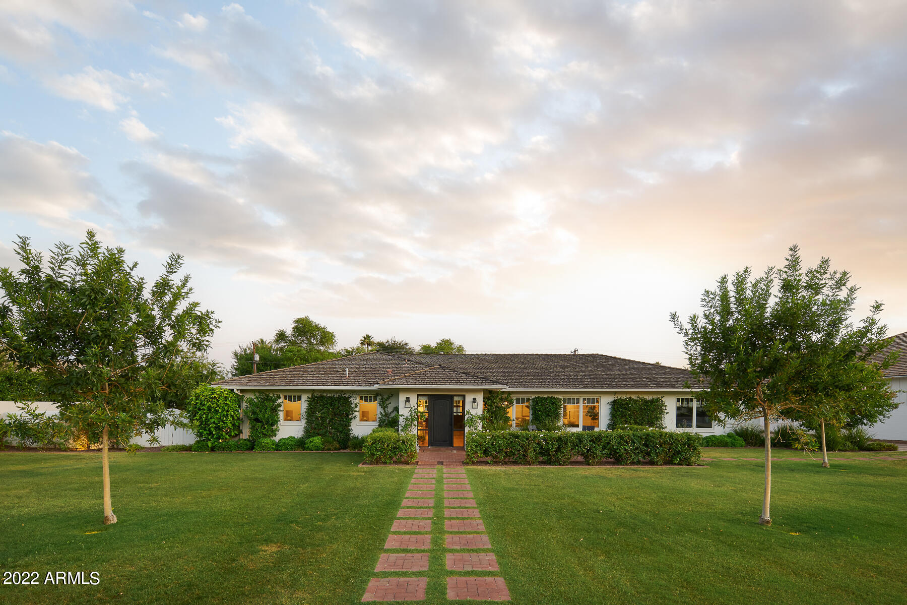 Warm and welcoming family home that is both stylish and comfortable! This beautiful ranch home was completely renovated in 2018, creating an open great room concept with soaring ceilings, loads of 8' doors and windows that bring in plenty of natural light and welcomes the outside in. This entertaining home features 4 bedrooms / 3.5 baths plus an office.  Using only the finest of finishes, this home boasts warm, wide planked, white oak flooring throughout, custom tile work and top of the line appliances and amenities. Detailed trim work throughout with custom crown, door casing and baseboards. Chef's kitchen includes custom cabinetry, Wolf and Sub Zero appliances, quartz countertops, a spacious island for additional seating and storage and beautiful custom plumbing and light fixtures. Generously sized primary suite features walls of windows and doors opening to the sizable yard and pool, custom Cle tile work in the primary shower and flooring, custom cabinetry, gracious soaking tub and custom built out primary closet.  Spare bedrooms are spacious with one bedroom being ensuite with a private patio overlooking a shady side yard orchard that features an orange and a lemon tree!  

All of this sits on more than half an acre of lush green lawn with sprawling Camelback Mountain views! Entertaining brick patios sweep the rear of the house and overlook the sparkling 30' long pool with baja step and custom patterned tile line. So much to enjoy about this wonderful home and plenty of room to add your own special touches!