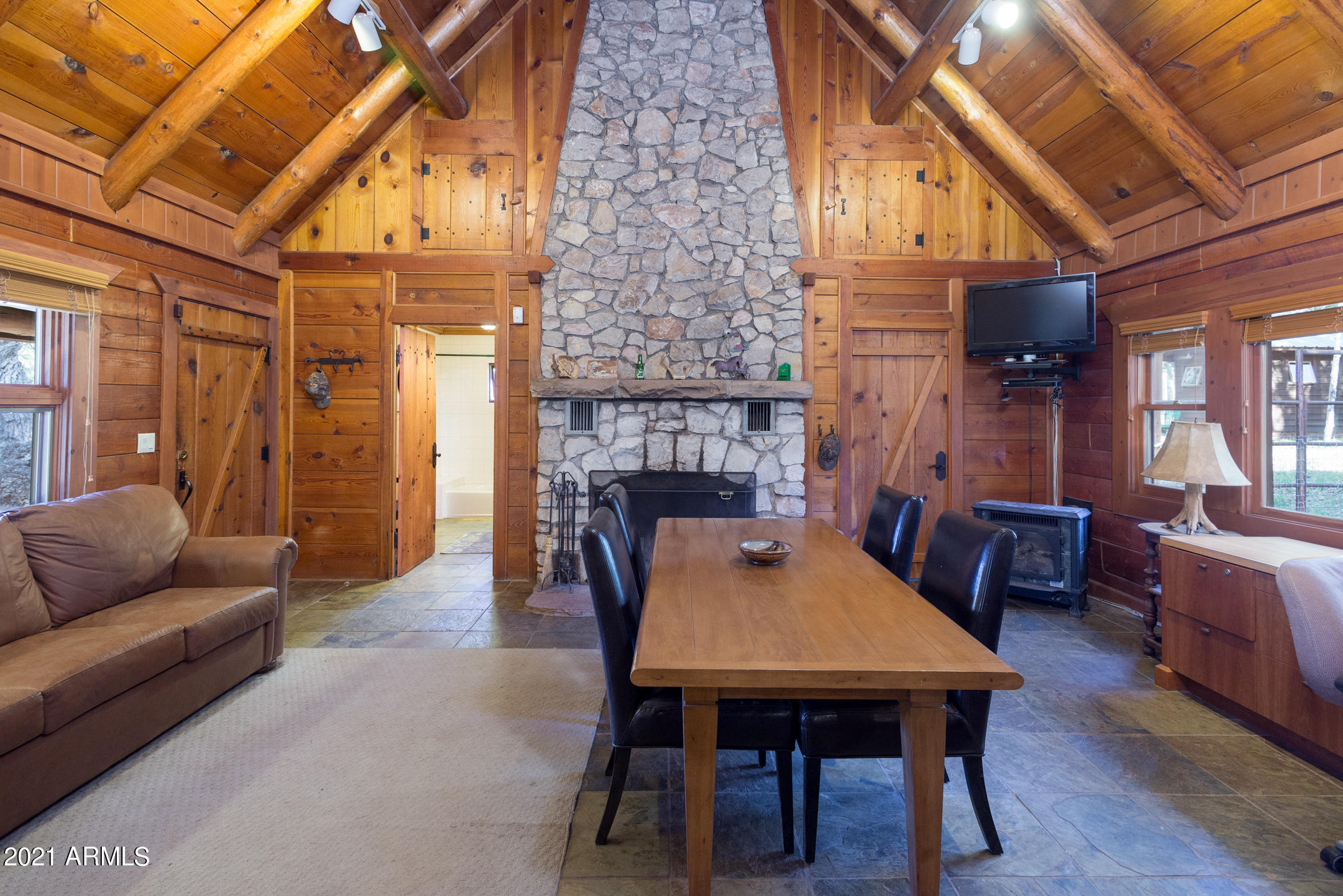 Rare opportunity -This property is located 35 miles South of Flagstaff, and only 3 miles off Lake Mary Road. Enter the property via a private gravel road thru a forest of tall Ponderosa Pine, Aspen and Oak.  Over 75 acres of heavily treed property with meadows bordering National Forest Service on 2 sides. 3 log cabins, 5 bunk houses, 6 horse barn with turn out, fenced and cross fenced. All with metal roofs. Private Well and Forest Service Spring rights. Extensive solar array to power all structures, including barn with pre-wired sites for more. Wind generator and propane backup generator on site. Propane delivery available. New cell tower in area. Endless Options!
No Winter access as Forest Service does not plow FS 135. 
Includes APN's 40210005,40210006,40210004A,402100003D and 40210003 CK Ranch at Mahan - List of Property Features
Our 75-acre ranch, located near Happy Jack, AZ, sits in the mountainous, lushly forested portion of northern Arizona, with ponderosa pines, fir, aspen, oaks and an abundance of natural forest beauty. Situated along the eastern slope of Mahan Mountain, the property represents approximately one-half of the historical 160-acre Mahan Ranch, which was established by the Mahan family in the 1880s, and which today is completely surrounded by the Coconino National Forest. Our ranch is completely utility- independent, powered by solar power with generator backup, and propane for heating. An independent well provides water for the ranch. With more than 5,000 combined sq ft of livable space, the property includes 3 log cabins, 5 bunkhouses, a beautiful 6-stall horse barn, and a large garage/workshop building. All 3 log cabins boast a magnificent view of the large, open meadow, perfect for grazing horses, and from which one has a clear view of Mahan Mountain. A description of each cabin follows:
Main House  2,452 sq ft of livable space, built in 2002, includes 1 large master bedroom with full bath, 1 large, open loft which easily could be split into two bedrooms, a living room-dining room combination, open kitchen that separates the living-dining room from a great roomcomplete with stone fireplace. There is a 2nd full bathroom, and a separate laundry room with lots of space for storage. The main house, completely custom-built with plenty of unique features, was constructed with a solid D- log exterior, pine tongue & groove interior, metal roof, slate tile flooring in the kitchen and great room, solid cherry flooring in the living-dining room and master bedroom, and carpeting in the loft. A large covered patio in front of the house provides a great view of the meadow, and a second covered patio in back looks out onto National Forest. Both patios have slate tile flooring; additional flagstone walkways and open patios surround the house on 3 sides. The house is solar-powered and also has two 500-gallon propane tanks that serve both the main house and guest house for heating; the main house and guest house each have their own septic system.
Guest House  With 750 sq ft of livable space, this house of solid log construction was built in 1906 and refurbished in 1999. It has 1 large open great room with a modernized wood-burning fireplace. The full eat-in kitchen and a full bathroom were added on in 1999, built with shiplap exterior siding, pine tongue & groove interiors, and a metal roof. Also in 1999 solid maple flooring and Andersen windows were installed throughout the cabin.
5 Bunkhouses  The property includes 5 charming bunkhouses all situated just beside or behind the main house. The bunkhouses each have approximately 120 sq ft of livable space, were reconstructed around 2001 with shiplap exterior siding, pine tongue & groove interiors, metal roof, solid maple flooring, and Andersen windows. The bunkhouses all come furnished with 2 twin beds (cherry pedestals with storage drawers underneath), side table and chair.
"Kenny Cabin"  A third cabin sits separate from the main house and guest house, and is named for an earlier owner of the ranch. The Kenny cabin is a rustic, solid log-constructed cabin built in the
 
1970s which provides 1,292 sq ft of livable space, including one large great room that originally included a kitchen built into one corner, 2 bedrooms, 1 bath with clawfoot tub, and an open loft. This cabin does not currently share in the ranch's main water supply, but sits on a parcel which owns water rights from a nearby spring. The cabin has its own septic system, 500-gallon propane tank, and 2,500-gallon above- ground water storage tank.
6-stall horsebarn  The 1,728 sq ft barn was built in 2005 with 6 interior/exterior stalls, including interior floor mats and exterior pipe-fenced pens. The barn was constructed of steel framing, tongue & groove wood siding, and concrete foundation. The barn is fully enclosed and has full power with shared water from the garage/workshop.
Garage/Workshop  Built in the 1970s of solid log and rock construction, the garage/workshop building sits next to the barn, is 756 sq ft with a 16-ft high peaked ceiling. The garage includes a large, enclosed tool/storage room with storage loft above, and has full power with water plumbed to the outside of the building.
Power and Water The property is completely power- and water-independent ("off the grid"). There are 4 solar arrays, each with 6 SolarWorld SW280 panels that generate 1,680 watts for a total of 6,720 watts of power. The solar power system supplies electricity to every structure on the ranch (including the Kenny cabin) and is backed by a 15 Kw propane generator. A gravity-fed water system supplies water to the main house, guest house, and garage/workshop. A 35-ft deep independent well on the property supplies the water, which is pumped to a 2,500-gallon underground water storage tank.