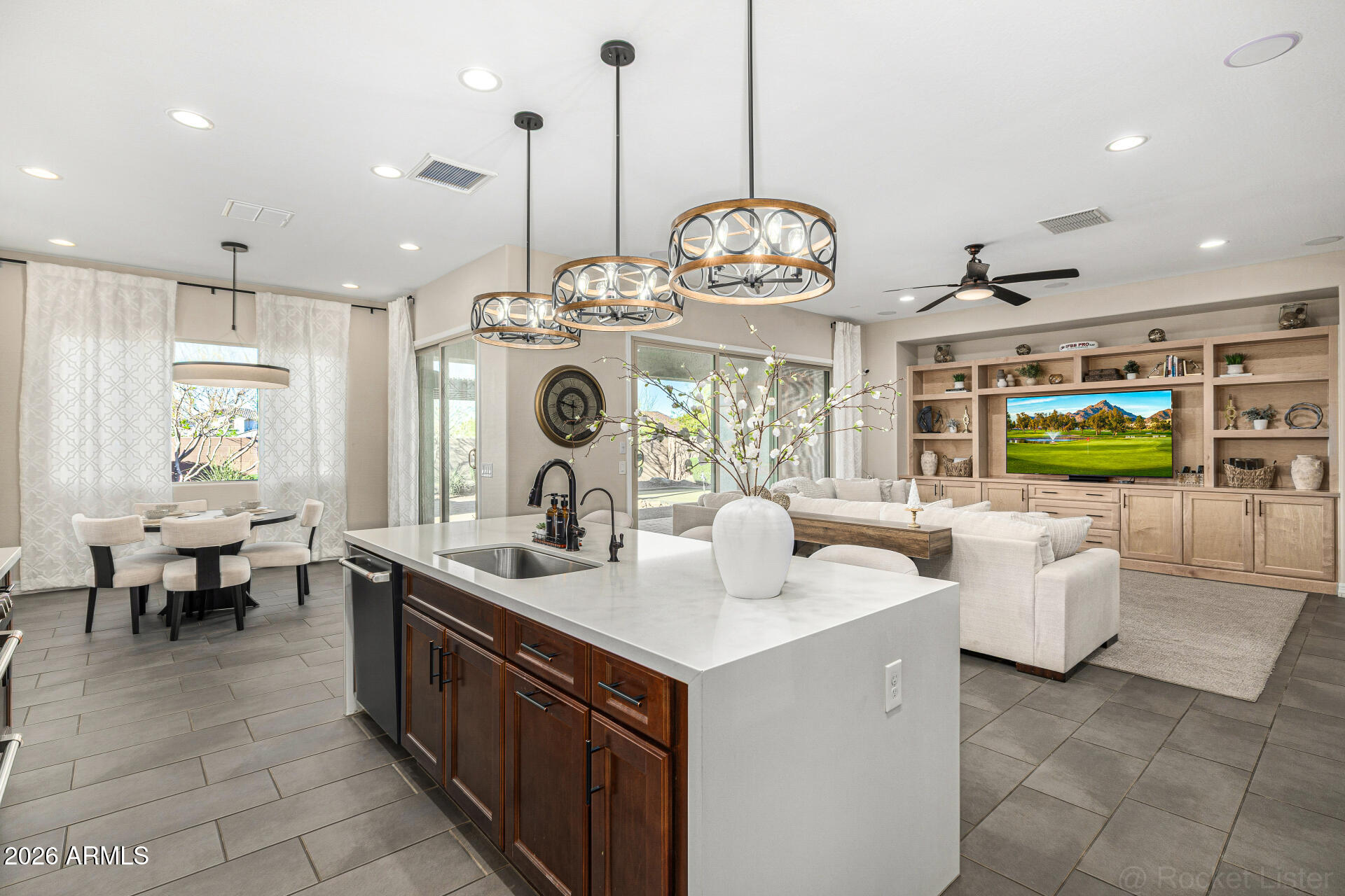 Former Model | $220K+ upgrades | Mountain Views | Mins from the 202!! Former model home with over $220K in designer upgrades, park-facing with mountain views! This stunning plan features wood-look tile, upgraded carpet, custom lighting/fans, surround sound, and a built-in entertainment center. Gourmet kitchen with gas range, quartz countertops, tile backsplash,42''maple cabinets, stainless appliances, and a waterfall island with seating. Spacious great room with MULTI-SLIDE doors for seamless indoor/outdoor living. Backyard designed for Arizona living with built-in BBQ, gas line, pergola, pavers, and putting green. Fresh interior paint, water softener, filtration system under kitchen sink, upgraded front yard with extended pavers, smart AC controls, and twilight lighting.Easy access to 202 Easy access to Loop 202 to go to Chandler Located Minutes away from the South Mountain loop 202 to easily travel to East or west valley. This home is filled with so many upgrades that the pictures don't show the True Beauty of the home.