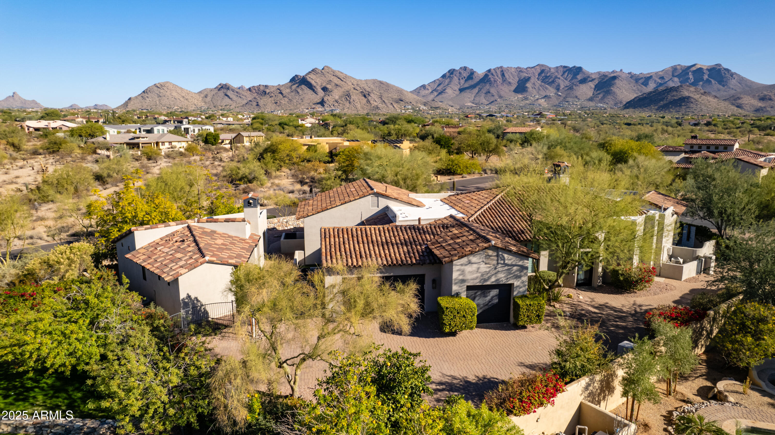 Exceptional newly remodeled ranch estate with private entry guest residence is perfectly situated in the heart of North Scottsdale, nestled in the charming 23 home gated community of Toscana, this private one-story home community is a hidden gem.  Fully remodeled with current designer finishes, including wide plank hardwood flooring, new kitchen cabinets and appliances, smart hidden pantry, sleek wine wall, with impressive wood base and wood wall/ceiling finishes.  Desirable great room home plan offers seamless indoor-outdoor living with spacious open eat-in kitchen opening to courtyard and family room, dining, and wet bar, with nearby den opening to courtyard, ideal for entertaining.   Enjoy McDowell Mountain views from the lux backyard with an eat-in ramada with BBQ and pizza oven, heated pool/spa, covered patio, turfed grass area and private outdoor shower.  Convenient yet private detached guest house is fully equipped and stylishly finished with kitchenette and two bedrooms/office/exercise with private covered patio and access to backyard amenities.  Prestige location immediately south of DC Ranch, conveniently located just minutes from Pima and 101, shopping and restaurants, and schools, yet removed from the hustle and bustle.