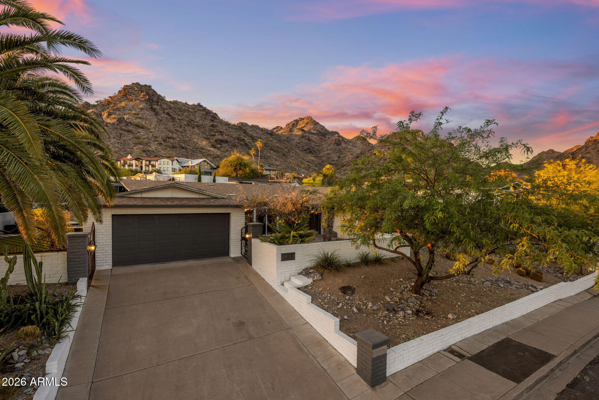 Tucked into coveted Indian Hills at the foot of Piestewa Peak, this is a home with a point of view--where mountain and city views frame daily life and the trailhead sits just beyond your front door. A bright, open split floorplan flows with natural light, anchored by an updated kitchen, generous bedrooms, and a private primary retreat. Out back, a sparkling pool sets the scene for golden Arizona evenings. What you can't always see matters most here: major systems have been thoughtfully updated for true move-in confidence. Enjoy lock-and-leave ease, hiking out front, and minutes to Biltmore dining, resorts, and easy freeway access. Distinctive, light-filled, and low-maintenance--ready for its next chapter. Some homes are about square footage. This one is about where you wake up. Set on a sought-after street in Indian Hills--one of Central Phoenix's most coveted pockets--2432 E Piestewa Peak Drive puts you at the base of the mountain, with the trailhead practically out your front door and uninterrupted mountain and city views as your daily backdrop.

Inside, the spacious split floorplan does exactly what a great layout should: it gives everyone room to breathe. Bedrooms are separated for privacy, the living spaces open up and fill with natural light, and the updated kitchen flows graciously into the dining area--made as much for a quiet Tuesday as for a houseful of people. Step out back to a sparkling pool and the kind of golden-hour evenings that make Arizona living worth it.

But here's what sets this home apart from the others you'll tour: it has been genuinely cared for, with the big-ticket systems already handled. These are the updates that don't show up in listing photos but show up in your peace of mind--and your inspection report:

New electrical panel (2026) -- modernized and ready for today's demands
New irrigation / yard watering system (2026) -- efficient, low-effort landscape care
New water heater (2026)
New EV car charger (2025) -- plug in at home, skip the public chargers
New pool heater and cooler (2023) -- swim comfortably across the seasons
New sewer line (2022) -- the kind of major-system upgrade most buyers only wish for

That's six significant updates spanning the home's core systems--electrical, water, sewer, irrigation, pool, and EV--all completed in recent years. For a buyer, that translates to fewer surprises, fewer first-year projects, and a home you can simply move into and enjoy.
The location keeps giving. You're minutes from Biltmore Fashion Park and the Camelback Corridor's best dining, a short hop to world-class resorts and Sky Harbor, and steps from some of the best hiking in the city. It's a true lock-and-leave lifestyle: low-maintenance enough for the frequent traveler, yet warm enough to call home.

Distinctive setting, thoughtful upgrades, and a layout built for easy living--this is Indian Hills done right.