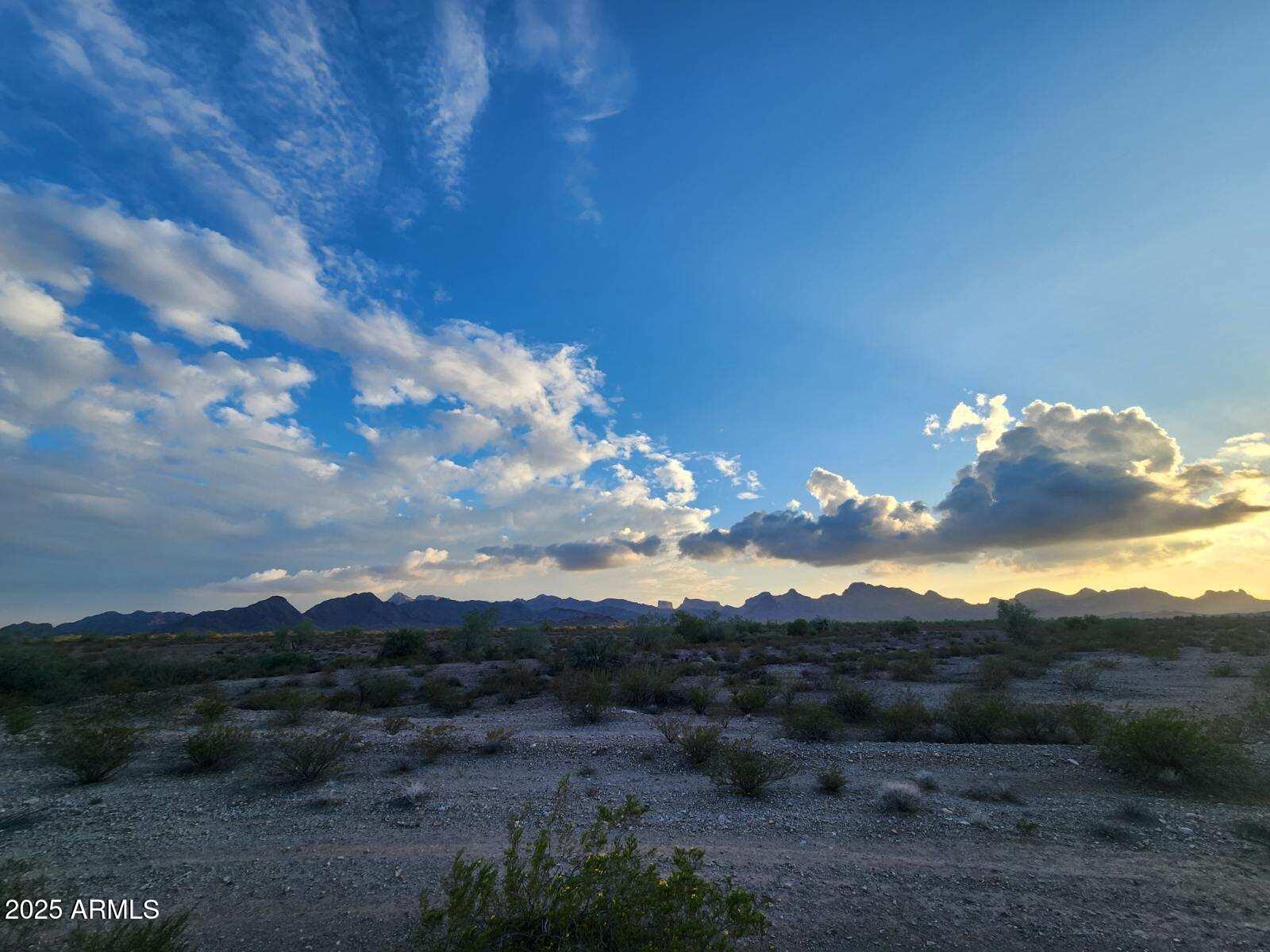 Dont miss your chance to own this sprawling 2.77 acre ranch, for just $4995 down, owner carry financing! This parcel is located just off 581st Ave and Camelback Rd. It has only a few neighboring homes, farms, and ranches, surrounded by amazing views of several mountain ranges. Majority of parcel is fenced, accessible by private drive.
Just a couple miles south of I-10, offering privacy and seclusion for your custom home, or family compound.