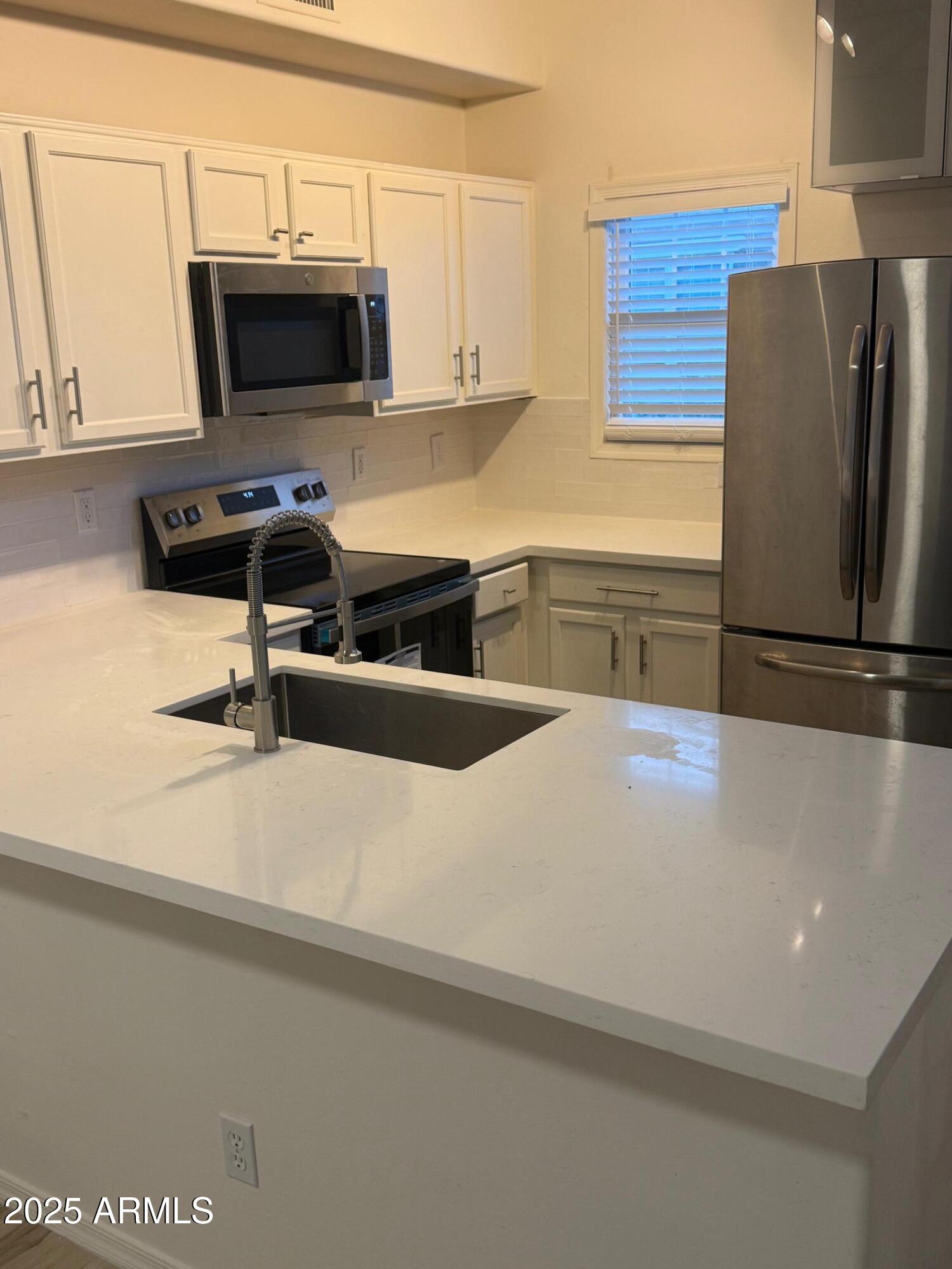 Beautifully updated 3-story townhouse in the heart of Gilbert, offering 2 bedrooms, 2 bathrooms, and a spacious loft-style living room. This move-in-ready home features new flooring throughout, a fully remodeled kitchen with modern finishes and new appliances, and refreshed bathrooms with new vanities and shower fixtures. Major mechanicals are taken care of with a new water heater and recently replaced AC. Located in a highly desirable community close to shopping, dining, and parks, this home delivers comfort, style, and low-maintenance living perfect for homeowners or investors alike.