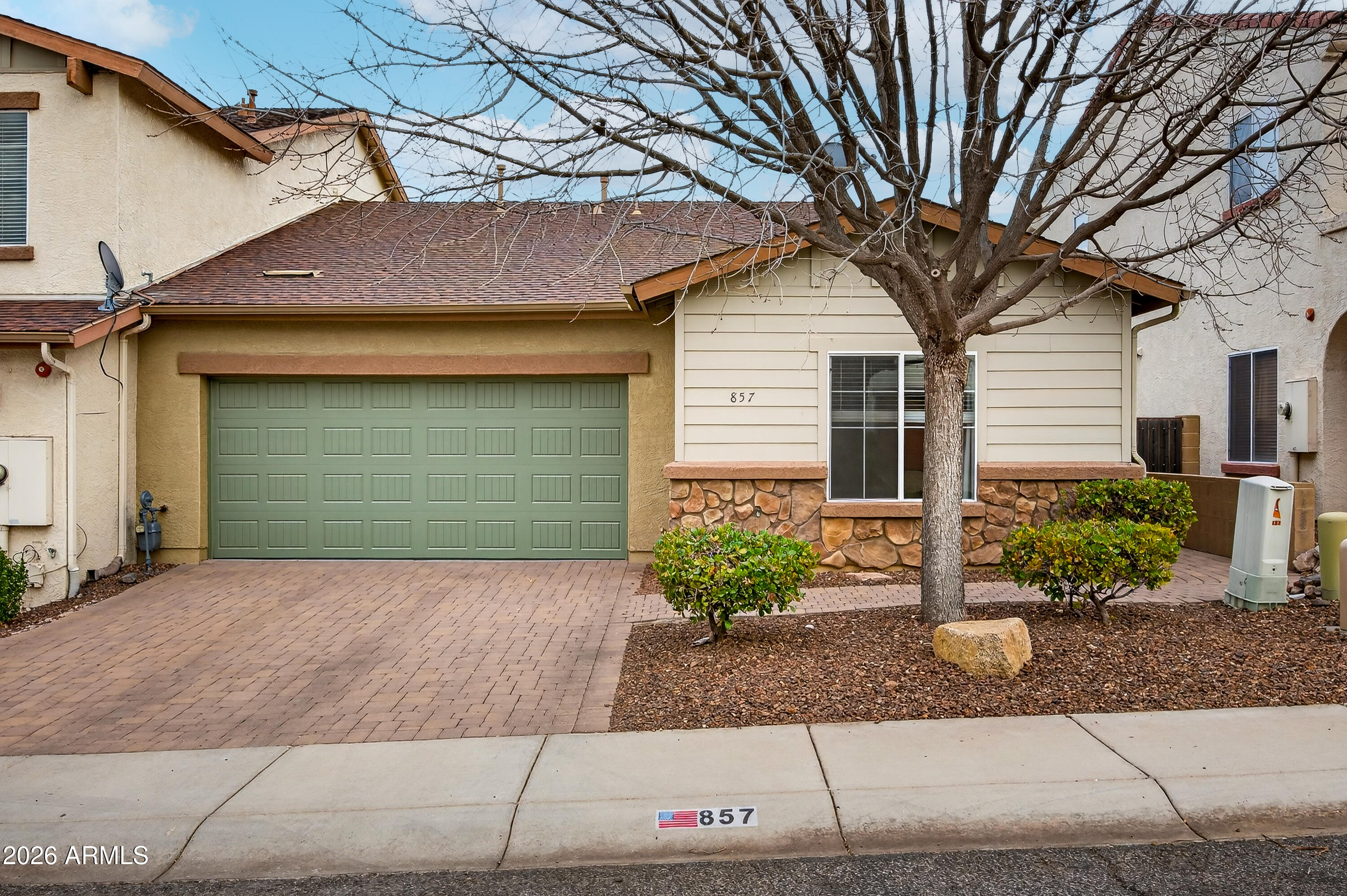 Your chance to lock in an incredible low-maintenance lifestyle in Clarkdale's highly sought-after Mountain Gate community is here. This pristine townhome is priced for action and ready for its new owner. The flexible floor plan features 2 spacious bedrooms, 2 full baths, plus a versatile den that is perfect for a home office, hobby room, or guest space. The kitchen comes fully equipped with updated appliances and an open layout ideal for entertaining. The oversized two-car garage offers plenty of extra storage space. Best of all, you are just steps away from neighborhood pickleball courts, trails, playgrounds, and community gardens. Walk to Clarkdale's historic district for new restaurants, the local brewery, and charming shops. HOA covers the roof and exterior maintenance.