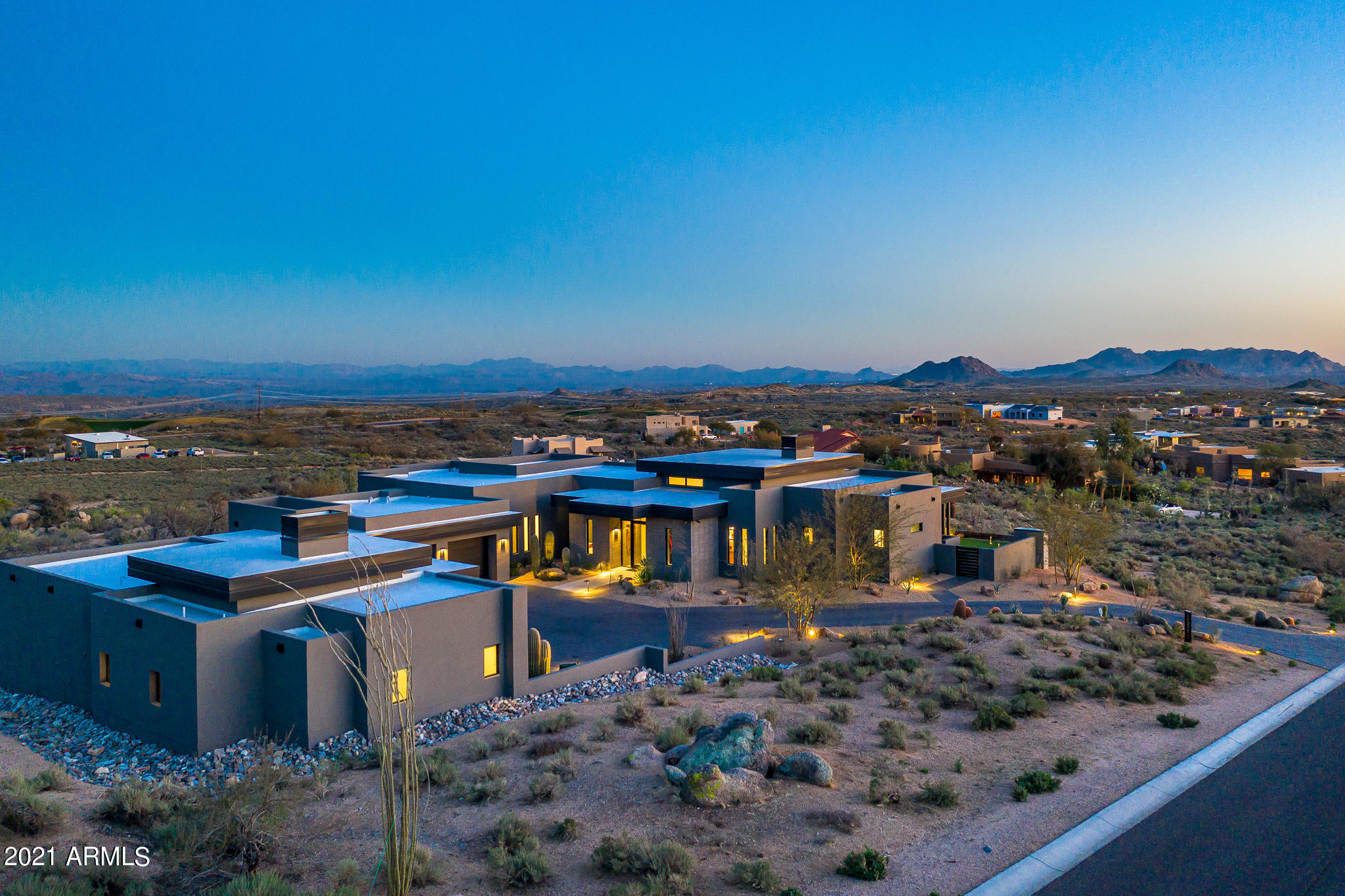 A contemporary masterpiece sitting on over 2 acres with ''million dollar'' views in all directions.  Designed and built to take advantage of the spectacular setting.  
Enter into the spacious great room with a sliding wall of retractable glass doors opening to the patio, pool, spa and endless views. Kitchen, dining room, bar and walk in butler's pantry add to the open floorplan.  The quality of finishes and products used in the home are everywhere to be seen.  Two large bedroom suites in the main house and a separate casita with a 3rd bedroom suite and living area.  A total of 4 car garages and extra large parking and entrance court.  Minutes from the front gate at Desert Mountain and across the street from the Desert Mountain Outlaw golf and clubhouse. Perfect blend of home and land.