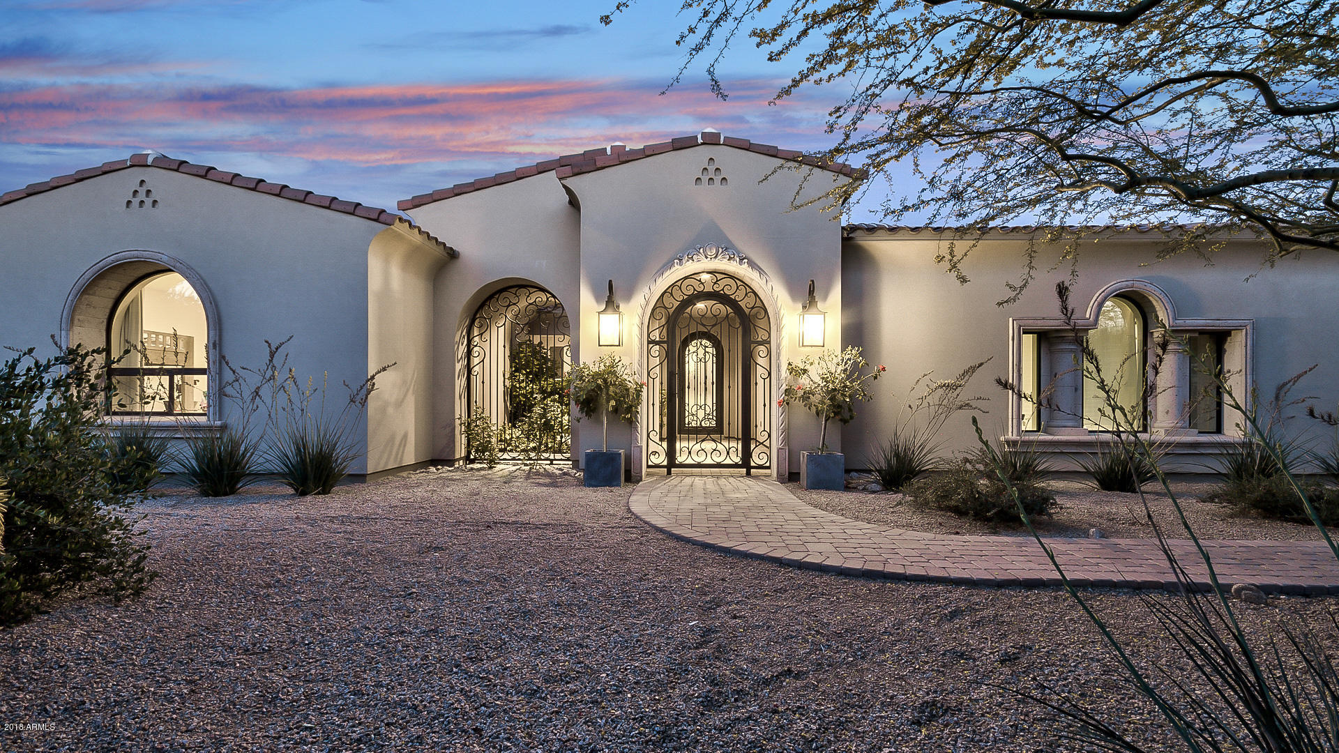 HUGE PRICE REDUCTION!! A stunning and private home awaits in prestigious Paradise Valley community. Nestled behind a wall of privacy trees, and gated parking this home boasts a beautiful landscape complete with lush green grass and sparkling blue pool perfect for entertaining. This home has a spacious layout boasting 6 Bedrooms, and 5.5 Bathrooms with over 7,100 square feet of open living space. Whether you're relaxing in the master retreat with fireplace, and spa like bathroom complete with large walk-in shower and tub w/his and hers separate custom closets. Enjoy the gourmet kitchen complete with large island, white and wood finish cabinets, chandelier and high-end appliances. This home also features a wet bar, movie theater and 2 separate 2-car garages. This home is a must see
