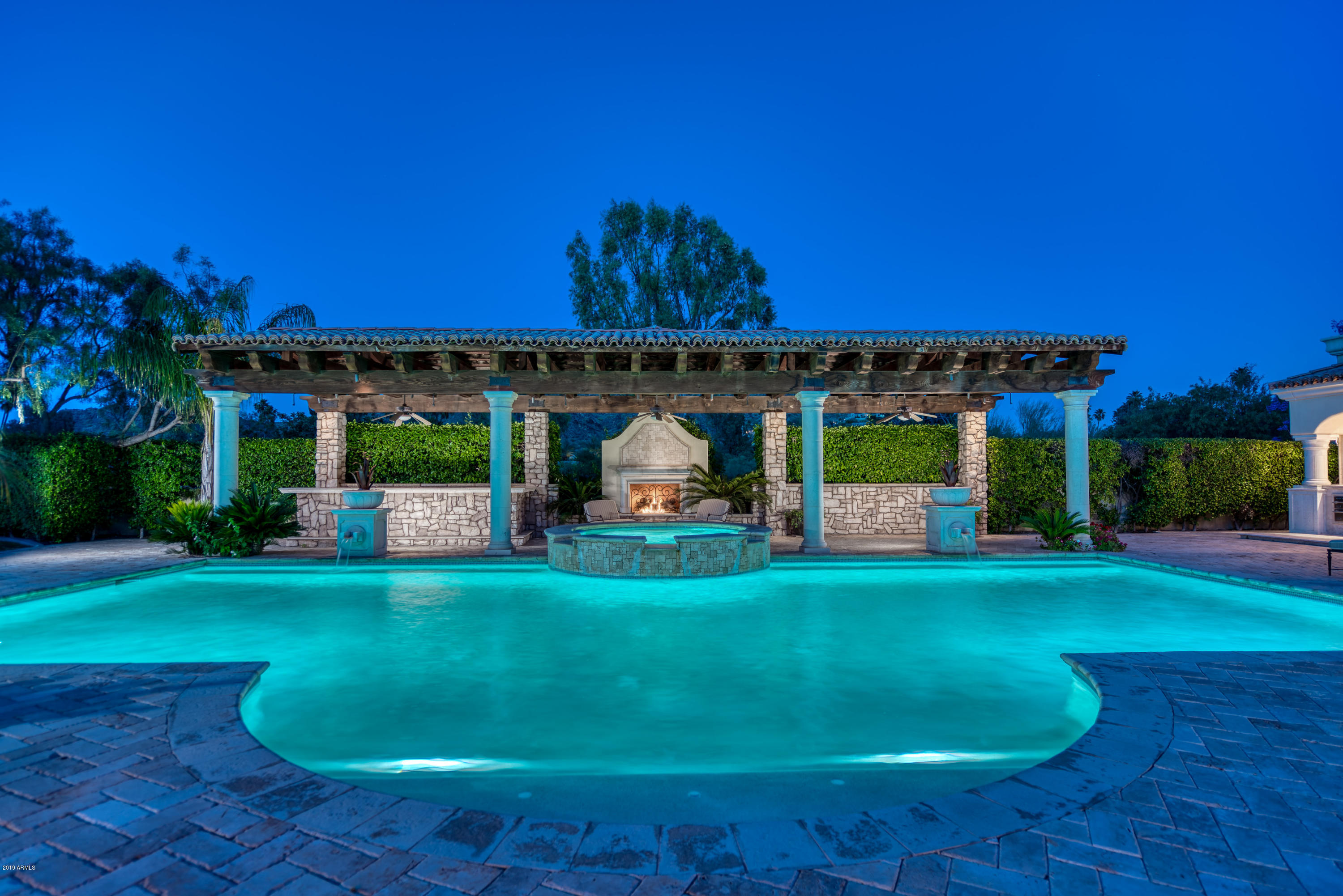 REDUCED TO SELL!   DON'T MISS OUT ON THE OPPORTUNITY! Known for luxurious residences surrounding Paradise Valley Country Club, this home delivers an amazing effect! Privately gated custom home featuring superb interior and exterior entertaining options. Entering the primary residence foyer you are immediately captivated with the exquisite finishes and professional interior design. Master Suite is truly exceptional. It includes huge walk-in closet, gorgeous bath and private workout facility. Formal living/dining, Office, 3 guest rooms, open kitchen to family room and detached Guest Casita complete the Estate. For Outdoor enjoyment; expansive pool, Ramada, fireplace, walk up bar & BBQ area. This home is truly one of only a few homes in Paradise Valley offered at such a competitive price!
