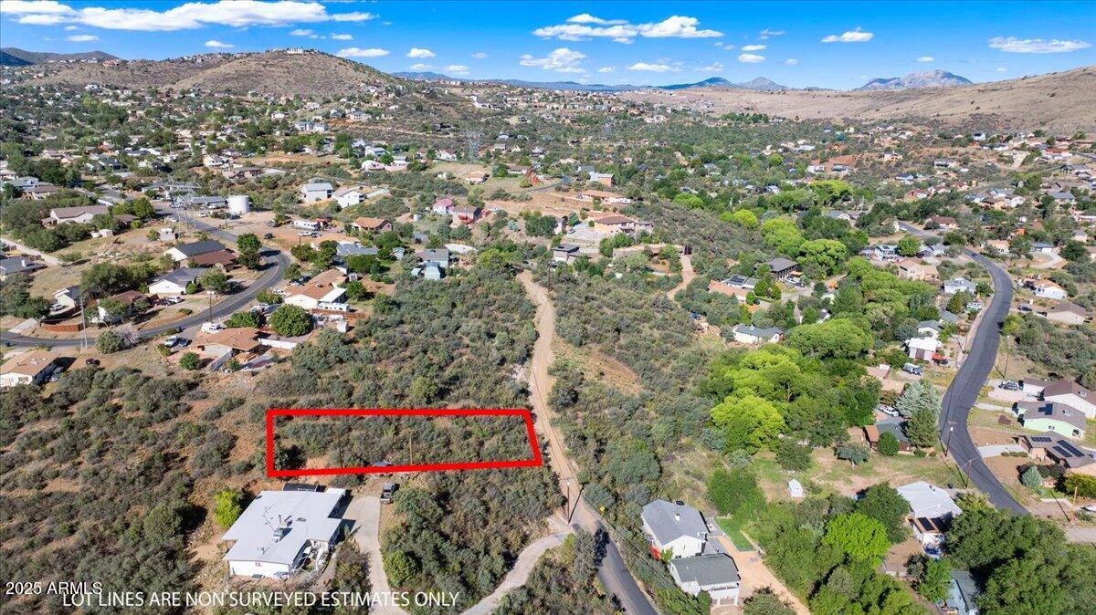 Don't miss your chance to own a beautiful hilltop lot in the sought after Diamond Valley neighborhood of Prescott AZ. Nestled at 1633 N Emerald Drive, this 0.26 acre parcel offers breathtaking mountain views and a unique opportunity to enjoy the peaceful country feel while being just minutes away from shopping, dining, and medical services along Highway 69. With a gently to steeply sloped terrain, this lot provides the perfect elevation for a custom site built home that takes full advantage of the stunning natural surroundings.

The property is zoned for residential use (R1L12) and located on a quiet county maintained dirt road, making access easy while still providing that off the beaten path privacy. Utilities are nearby with electricity and private water available, so you're one step closer to turning your dream home vision into reality.

Whether you're planning your forever home or looking for an investment with potential, this property is ready for your vision. With no HOA, low annual taxes, and a Prescott address, it's a rare combination of affordability and location.

Thinking bigger? The adjacent lot at 1627 N Emerald Drive is also available for purchase. Don't miss out on this amazing opportunity to own in one of Prescott's most conveniently located communities. Build your dream retreat and enjoy the serene mountain lifestyle you've been waiting for.