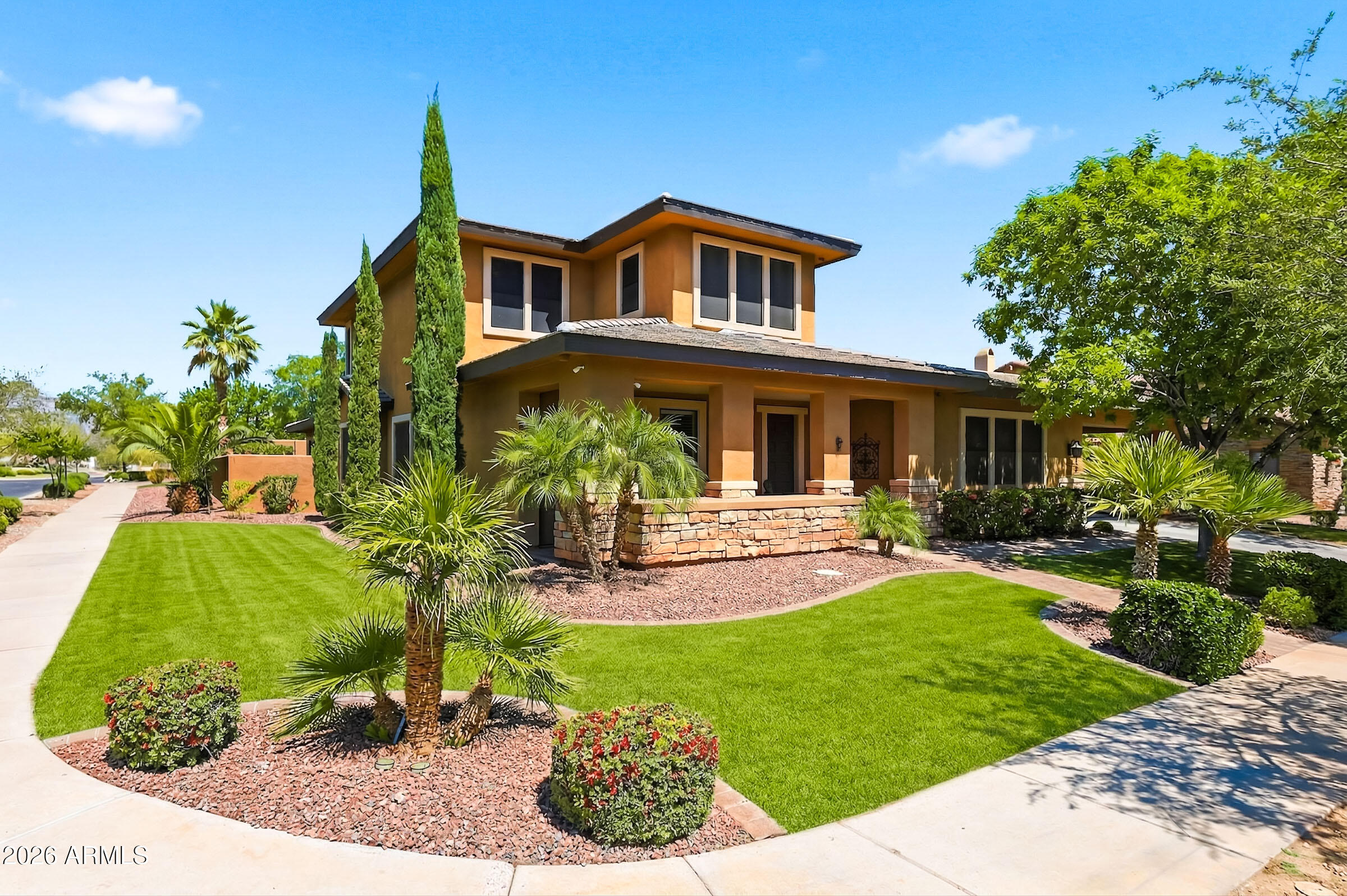 Nestled in the heart of Verrado, this beautifully updated 5-bedroom, 4-bathroom Desert Prairie-style home with a 3-car garage blends clean architectural lines, warm earth tones, and seamless indoor-outdoor living. Meticulously maintained, the residence offers a perfect balance of comfort, style, and functionality. The chef's kitchen is a standout, featuring a large island, 6-burner Dacor gas cooktop with pot filler, double ovens, hammered copper sink, custom cabinetry with abundant storage, and stunning granite countertops - ideal for both everyday living and entertaining. The adjacent great room is warm and inviting, highlighted by a striking stone gas fireplace and custom built-in cabinetry. The main-level primary suite serves as a private retreat with a cozy sitting area, expansive walk-in closet, and spa-like bath complete with a soaking tub and oversized shower. A dedicated home office provides the perfect space for remote work or study, while the upstairs loft offers flexible living space for a media room or play area. Step outside to your own private oasis featuring a charming courtyard, covered patio, sparkling pool with a slide and waterfall grotto, a cedar gazebo, and mature landscaping that enhances both beauty and privacy. Ideally located near Verrado's vibrant Main Street, with access to pools, fitness center, golf, parks, and scenic trails. This is a rare opportunity to own a thoughtfully designed home in one of Buckeye's most desirable communities.