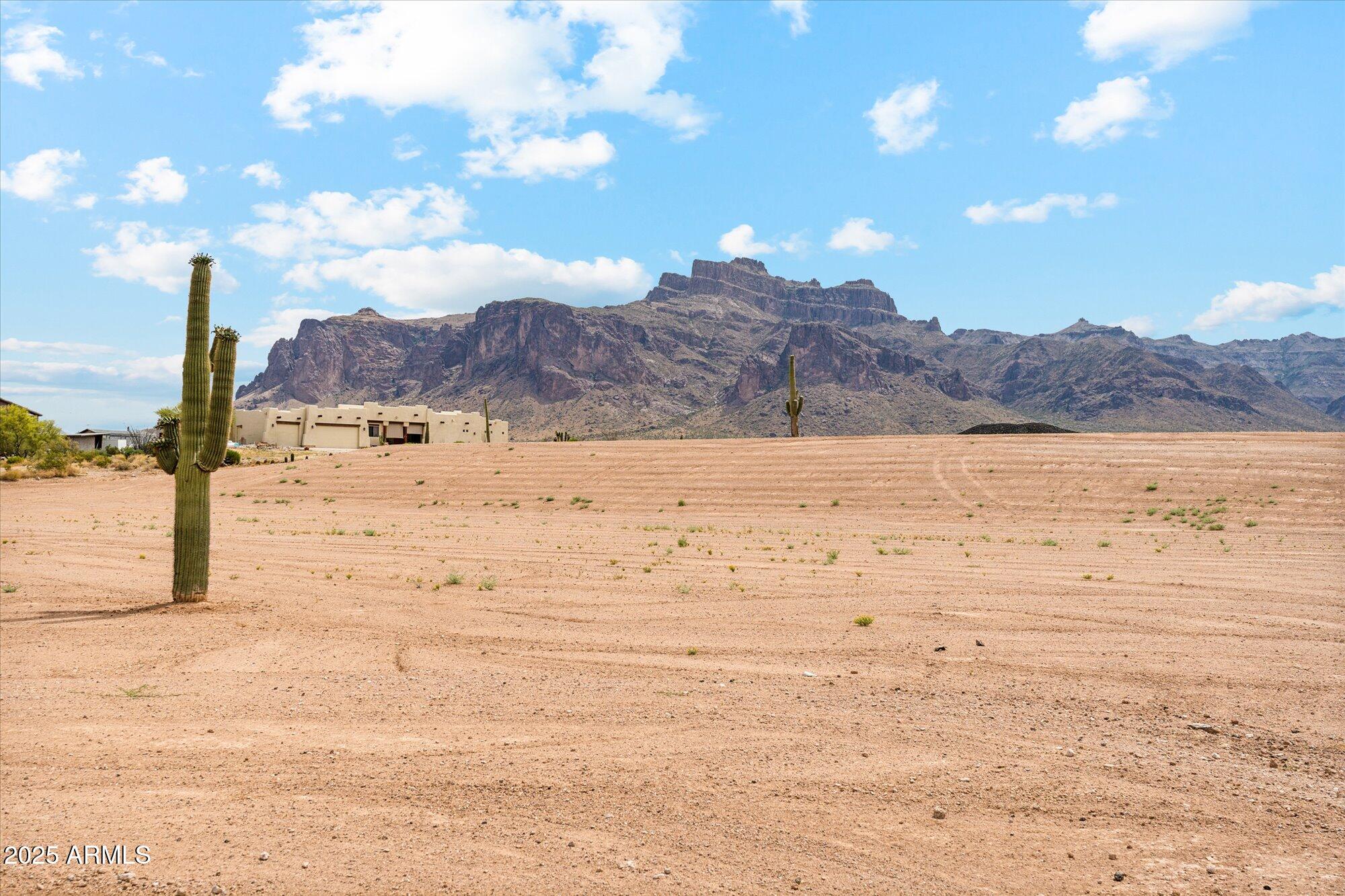 Build your dream home on this stunning 1.25-acre lot that's graded & ready to build with a Domestic Water Well coming soon to this property! Must See to fully experience the privacy, breathtaking mountain views, & peaceful quietness of the location. The natural wash to the west provides an added sense of space & tranquility, making this lot feel even larger & more private. The Superstition Mountain views are spectacular, photos simply can't capture how close & vivid they appear from every direction. With no HOA, you'll enjoy the freedom to design your property exactly the way you want it. Whether you've always dreamed of owning horses or simply want room to roam, this property offers the ideal setting. Located just minutes from mountain lakes, state & federal land, & miles of hiking & horseback riding trails, you'll have endless outdoor adventures at your doorstep. Despite the serene, rural atmosphere, you're still close to shopping, dining, and entertainment with easy freeway access to town conveniences.

Thousands of dollars in fill dirt and professional grading have already been completed, making this lot truly build-ready. Don't miss this rare opportunity to own a piece of Arizona desert beauty surrounded by stunning mountain scenery!