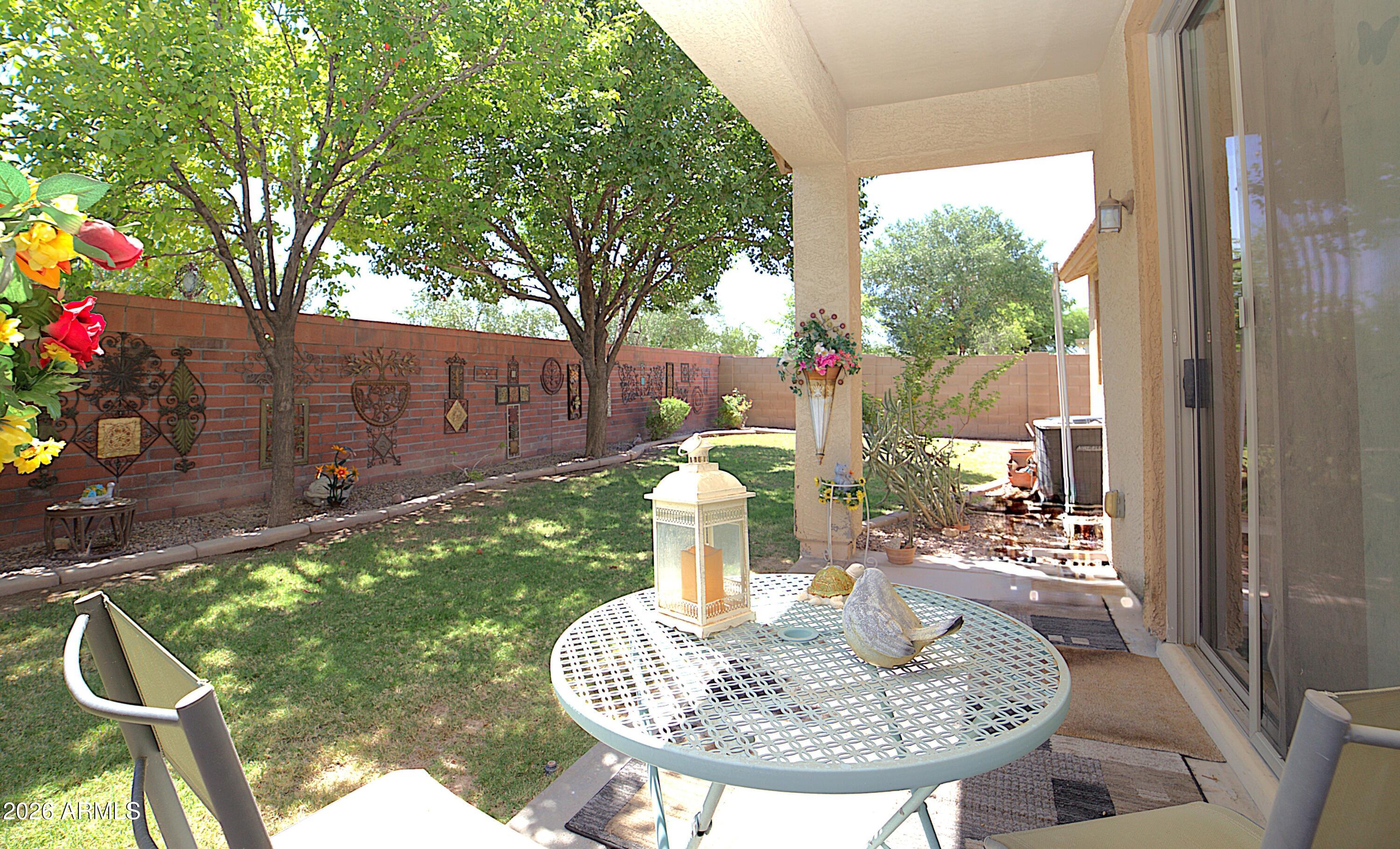 Owned Solar! Welcome to this 3 bdrm/ 2 bath home located in Cooley Station! Embrace the split floor plan that enhances privacy and flow, and a kitchen adorned with a stylish updated backsplash and a central island for added convenience.  The primary bathroom features a renovated shower and a spacious walk-in closet offering ample storage. The guest bathroom includes its own linen closet, ideal for organizing all your towels and extra storage. Step outside to find a lush green backyard with no neighbors behind, ensuring your outdoor space remains serene and private. This property does have newer owned solar panels and owned water softener. Enjoy the community pools and parks. Nearby you will find grocery stores, plenty of restaurant options, a movie theater and Mesa Gateway Airport