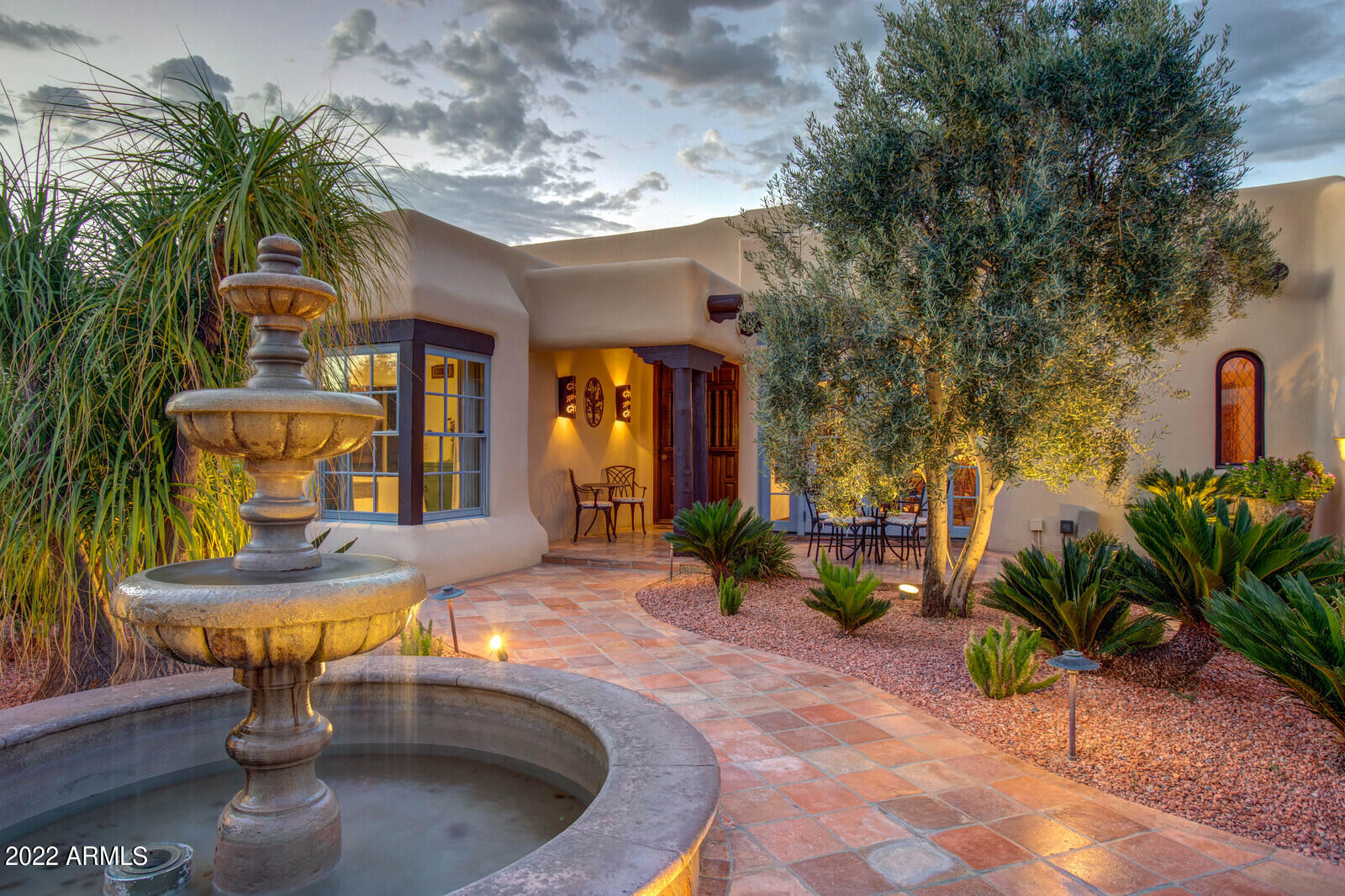 From the moment you enter the charming courtyard of this amazing territorial estate you are transported back in time with exquisite quality and timeless  architecture.  Shiloh Homes crafted the home with unique and special materials and finishes including the Boveda brick ceilings, hand-forged fixtures, and custom mill work that beautifully combines southwest and Spanish charm.  The main home features 5 bedrooms 4.5 Bathrooms, with both a formal and a casual living space, separate dining room, a true chef's kitchen that opens to the family room, a separate office and den along with an envious theater/wine room.   No expense has been spared for the outside entertaining areas as well with a resort pool, barbecue, playground set, sport court, putting green, play spaces, numerous patios and two beautiful imported fountains.  The guest house is just as impressive with custom finishes, 2 bedrooms and a separate living room.  An added bonus is an air conditioned 4-car spacious garage with tons of storage.  This is one that you will need to view to appreciate all the incredible nuances of  the home.