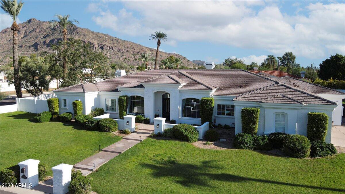 Spectacular 5 bedroom estate with Camelback Mountain views in Arcadia nestled on over an acre this  perfect split floorplan features soaring ceilings and spacious living spaces. Open and bright floorplan. Gourmet kitchen features a large island and top of the line appliances. Generous master bedroom suite with fireplace and an additional space for excercise area or nursery. 3 additional bedrooms are all en-suite with an adjoining flex/teen room. Private office near master wing could also be another bedroom. Inviting back yard features a covered patio, heated pool, spa and built-in outdoor BBQ, sport/pickleball court and RV gates for toys. You can't beat the location - minutes to Scottsdale Fashion Square and all the top restaurants/dining/entertainment