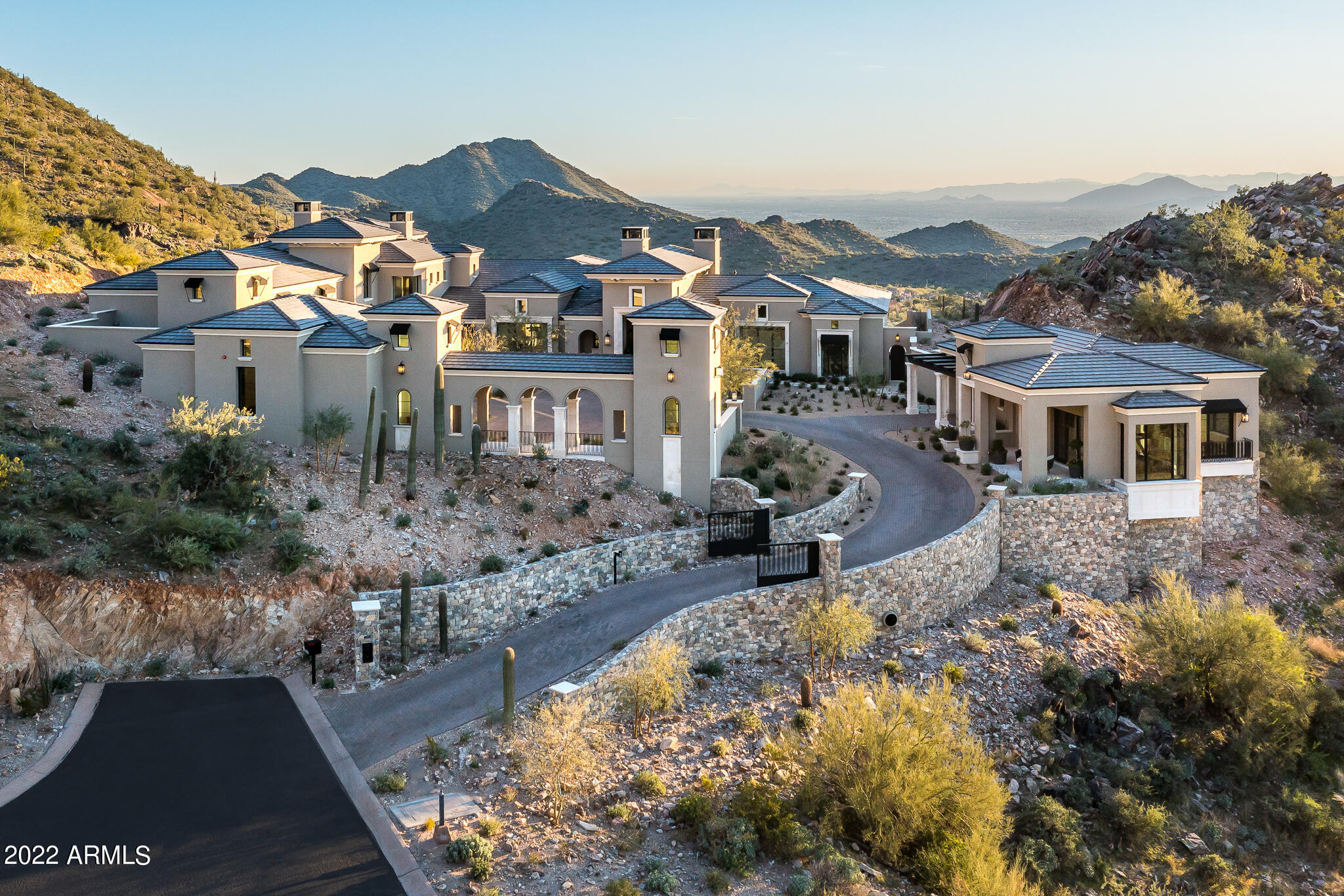 Perfectly situated within the prestigious community of Silverleaf, this 4.67-acre estate crafted by Salcito Custom Homes is a true work of art. Positioned in the coveted ''saddle'' of the Upper Canyon Summit, this grand residence offers a blend of warmth and sophistication with its unique French Modern interior-style and meticulous architectural design by Dale Gardon. From its commanding position, the home captures sweeping views of the Silverleaf Golf Course and the valley below. Upon entering, the superb interiors, a collaboration with Rebecca Salcito of the Salcito Design Group, you are immediately captivated. From the marble-carved fireplace to hand-blown glass chandeliers, and draperies fashioned from ombre alpaca fabrics, every detail exudes luxury. European Oak wood flooring graces every room.
Step through the welcoming foyer into an open floor plan that encompasses a captivating great room, a striking kitchen complete with a catering area, and a dining room featuring a wine wall. The kitchen showcases exquisite Bulthuap cabinetry, known for its clean design and unique features, including integrated appliances and a convenient breakfast cabinet. Both the main kitchen and catering kitchen boast Calcatta marble waterfall countertops with a leathered finish.

The main level houses the office, owner's retreat, and seamless outdoor living spaces. The owner's retreat is a sanctuary of its own, graced with a beautiful marble fireplace mantel and a sitting room adorned with picture windows and access to a private spa cove. The ensuite bathroom showcases marble flooring, showers, and vanities, along with custom wood cabinetry featuring integrated hardware, a matte white soaking tub, and a custom 14' Bubble chandelier. Upstairs, a private office or additional ensuite guest room awaits, while the lower level offers an entertainment area with a spacious family room, game room, and two more ensuite guest rooms.

As you approach the estate, a private gated driveway leads from the cul-de-sac to a generous auto court and garages, perfect for car enthusiasts with space for up to 11 vehicles. Additionally, a detached guest house offers incredible views, a living room, bedroom, and a separate garage.

Outdoors, you'll find spacious living areas complete with fire features, a double-sided pop-up television cabinet, multiple dining and sitting spaces, a sparkling infinity pool, and a secluded private spa adjacent to the master bath. This distinguished home is a true gem for the most discerning, destined to be cherished and revered.

Silverleaf, located in North Scottsdale, Arizona, is a prestigious guard gated community known for its luxurious estates, exclusive golf courses, private Club and stunning desert landscapes. The Tom Weiskopf-designed Silverleaf Golf Course is a highlight for golf enthusiasts. With a blend of Spanish and Mediterranean-inspired architecture, the community offers a high standard of living, including upscale amenities like spas, fine dining, and exclusive shopping. Residents enjoy a harmonious balance between modern luxury and the natural beauty of the desert environment, making Silverleaf a sought-after destination for those seeking an exceptional lifestyle in North Scottsdale.