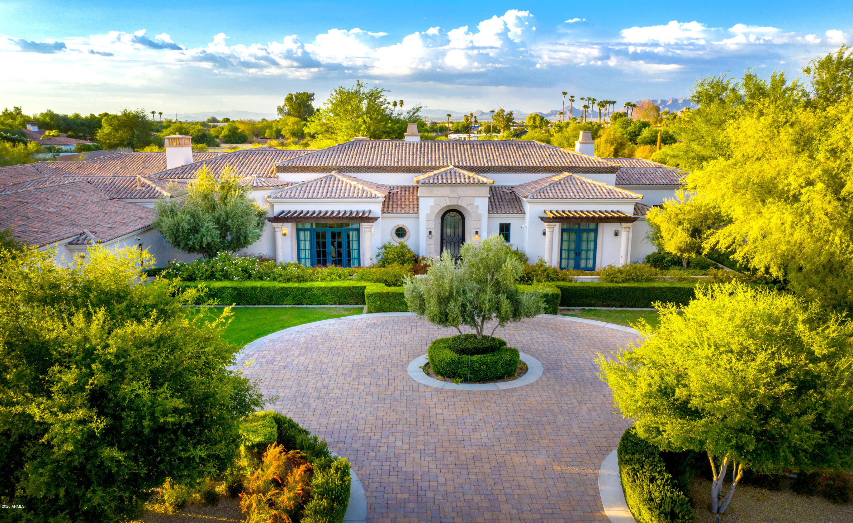 Opulent Santa Barbara estate in prime Paradise Valley location. This exquisite home is perfection from the inside out w/lush green manicured landscape, gated entry and circular pavered driveway. Grand foyer features limestone w/ Cantera marble accents. Elegantly designed and ornate finishes throughout such as carved beam ceilings, custom wood flooring, 3 stunning fireplaces, built-in bookcases, grid ceilings and gorgeous chandeliers. The gourmet chef's kitchen w/spacious center island, granite countertops, Subzero and Wolf appliances and a plethora of custom cabinetry. Soaring custom barreled ceilings in kitchen and formal dining. Amazing media room, bonus room w/full service wet bar and patio access. Additional features include a wine cellar, indoor/outdoor theaters and so much more.Take the entertaining outdoors and enjoy the sparkling negative edge pool and spa, putting green, built-in BBQ, covered patio w/bar and a ramada covered entertaining area. This home is an entertainer's dream! The property is also equipped with Control 4, allowing for remote control of lights, music, tv, alarm, etc. This home truly is one of a kind!