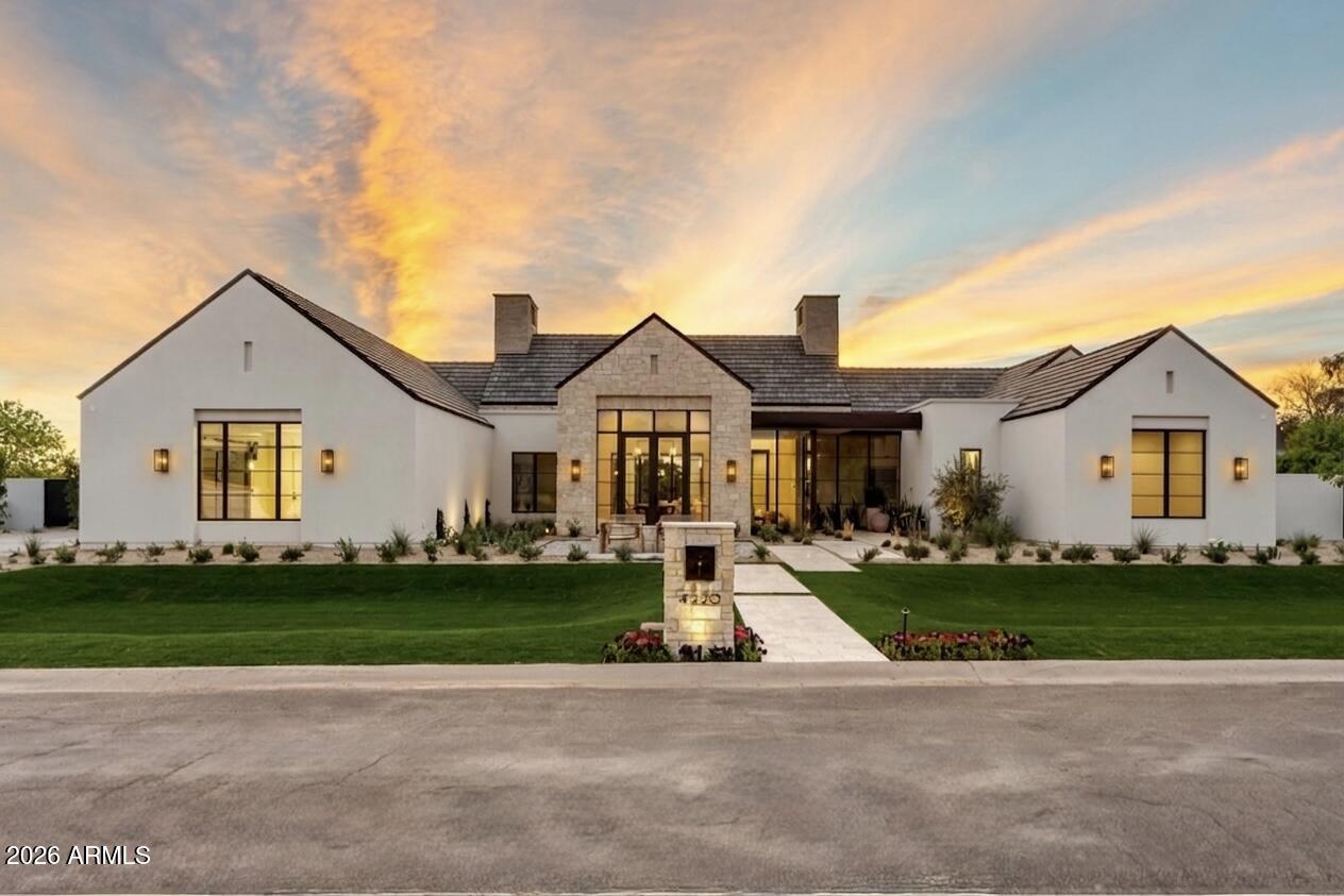 This contemporary design blends seamlessly with the surrounding Arcadia neighborhood while maximizing glass and true indoor-outdoor living. Set on a rare half-acre lot with no visible power lines, the home captures stunning Camelback Mountain views from nearly every angle. Built and designed by award-winning Rafterhouse, recognized for its level of craftsmanship and design, with architecture by Damon Wake of Studio Wake, no detail was overlooked in the craftsmanship and execution of this 5,933 sq ft residence, inside and out.

The home offers 4 en-suite bedrooms with oversized walk-in closets, a powder bath, office, and gym. Inside, soft natural stone introduces warmth and texture, coming to life under evening lighting, while expansive living, dining, and kitchen spaces are finished with top-tier materials, including a Wolf and Sub-Zero appliance package. The kitchen is complemented by a back kitchen and built-in coffee station, while a separate bar creates a true indoor-outdoor entertaining experience, complete with extensive wine storage, an ice maker, and dishwasher & beverage drawers. Hedged site walls and curated landscaping by Roots First provide privacy and continuity, anchored by a resort-style pool. All just minutes from Arcadia's best dining, shopping, and schools.