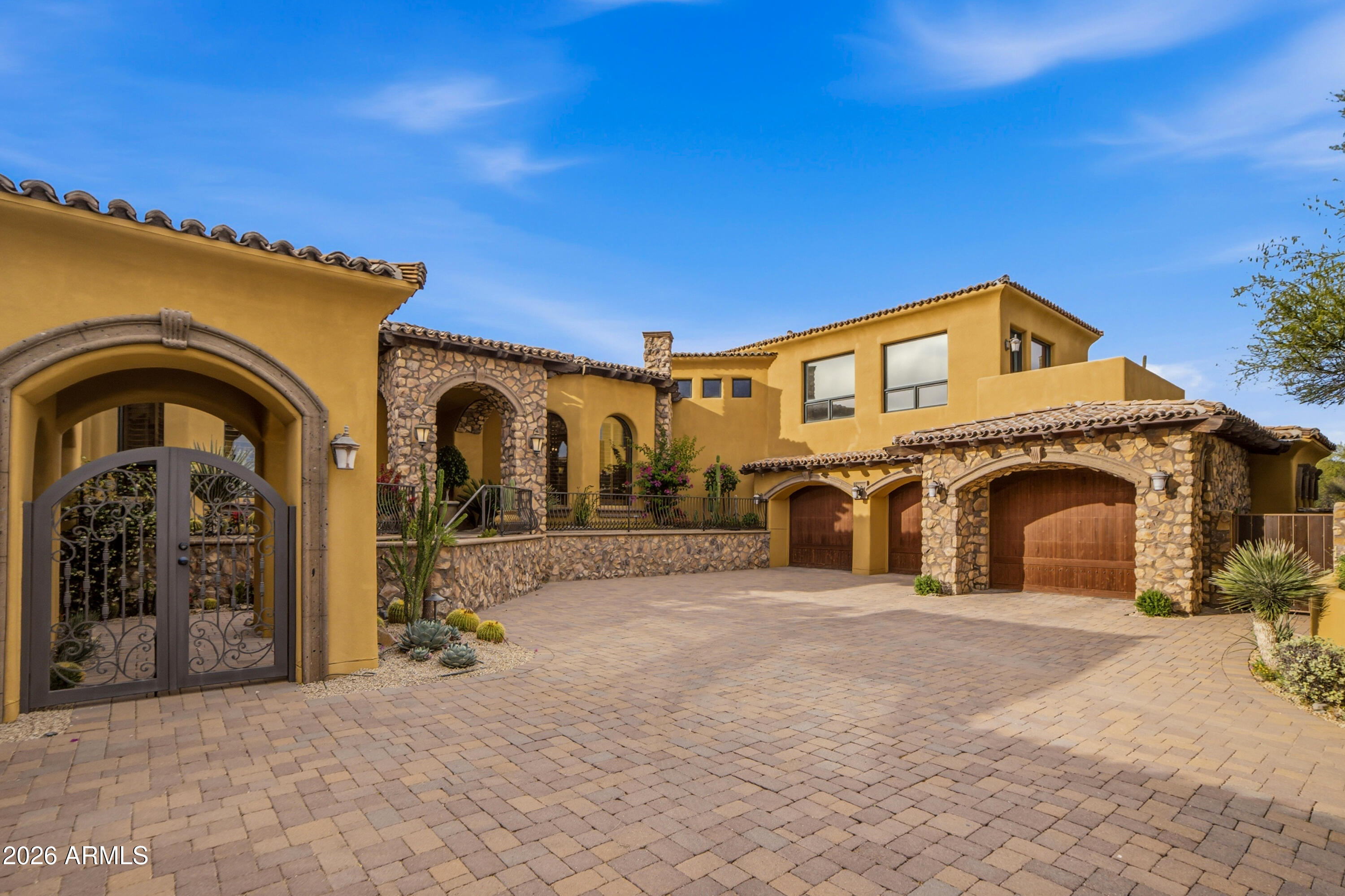 **GOLF MEMBERSHIP AVAILABLE.** Tucked within Desert Mountain's prestigious double-gated Saguaro Forest Village, this extraordinary estate captures a rare balance of elegance, artistry, and timeless design--an exceptional residence defined by craftsmanship and refined living. Perfectly sited on a private golf course lot, it offers sweeping views of the desert, surrounding mountains, vibrant sunsets, sparkling city lights, and the fairway beyond.
Recently refreshed with interior and exterior paint, the home is complemented by lush yet low-maintenance desert landscaping and a thoughtful floor plan that seamlessly blends formal living with flexible spaces for today's lifestyle. Rich materials--including extensive travertine, granite, and bespoke cabinetry--create a warm, sophisticated atmosphere throughout. At the heart of the home, the chef's kitchen is both functional and striking, appointed with double Sub-Zero refrigeration, a Wolf range, double dishwashers, double ovens, and generous prep and gathering space ideal for entertaining at any scale. The primary suite is a private sanctuary, featuring dual baths and closets, along with an intimate sitting room anchored by a fireplace and framed by serene golf course views. Additional living spaces include well-appointed ensuite guest bedrooms and a spacious bonus/game room complete with wet bar, view deck, and panoramic mountain and city-light vistas. A detached-style guest casita--complete with private entrance, kitchenette, full bath, laundry, and its own garage--offers elevated comfort and privacy for visitors or extended stays. Outdoors, the experience continues with a resort-style setting designed for effortless Arizona living: a pool and spa, built-in BBQ, and expansive travertine patio provide the perfect backdrop for both quiet relaxation and unforgettable entertaining.