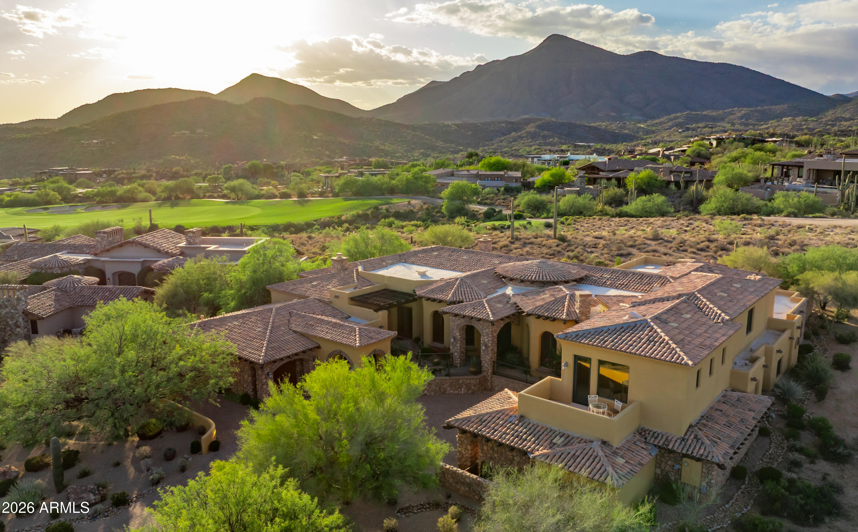 **GOLF MEMBERSHIP AVAILABLE.** Tucked within Desert Mountain's prestigious double-gated Saguaro Forest Village, this extraordinary estate captures a rare balance of elegance, artistry, and timeless design--an exceptional residence defined by craftsmanship and refined living. Perfectly sited on a private golf course lot, it offers sweeping views of the desert, surrounding mountains, vibrant sunsets, sparkling city lights, and the fairway beyond.
Recently refreshed with interior and exterior paint, the home is complemented by lush yet low-maintenance desert landscaping and a thoughtful floor plan that seamlessly blends formal living with flexible spaces for today's lifestyle. Rich materials--including extensive travertine, granite, and bespoke cabinetry--create a warm, sophisticated atmosphere throughout. At the heart of the home, the chef's kitchen is both functional and striking, appointed with double Sub-Zero refrigeration, a Wolf range, double dishwashers, double ovens, and generous prep and gathering space ideal for entertaining at any scale. The primary suite is a private sanctuary, featuring dual baths and closets, along with an intimate sitting room anchored by a fireplace and framed by serene golf course views. Additional living spaces include well-appointed ensuite guest bedrooms and a spacious bonus/game room complete with wet bar, view deck, and panoramic mountain and city-light vistas. A detached-style guest casita--complete with private entrance, kitchenette, full bath, laundry, and its own garage--offers elevated comfort and privacy for visitors or extended stays. Outdoors, the experience continues with a resort-style setting designed for effortless Arizona living: a pool and spa, built-in BBQ, and expansive travertine patio provide the perfect backdrop for both quiet relaxation and unforgettable entertaining.