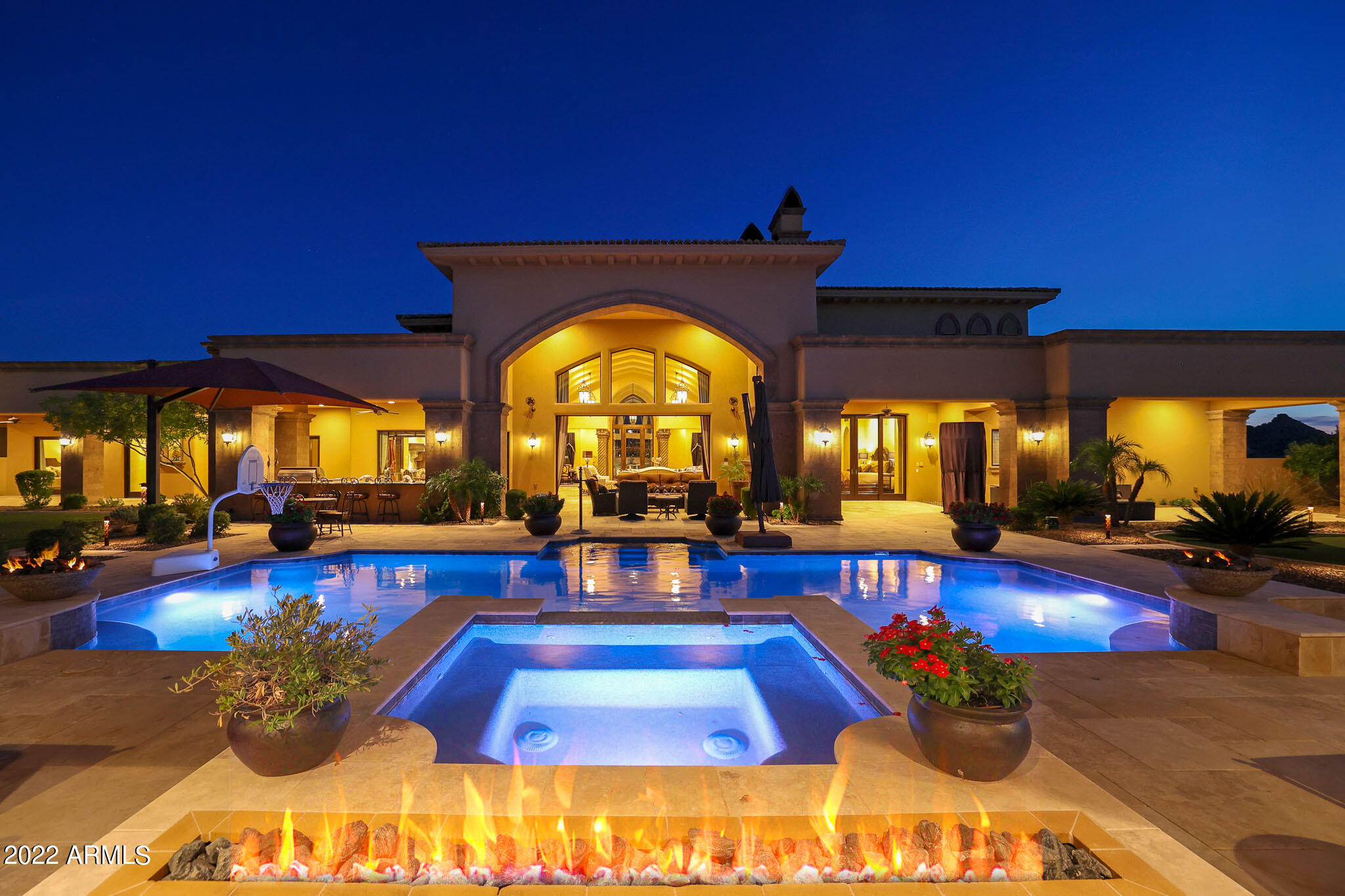 One-of-a-kind opportunity to own this soft Spanish Moor inspired estate located in the gated community of Troon Canyon Estates in North Scottsdale. Troon Canyon Estates is a small subdivision of twelve 2.5 to 3 acre homesites with a minimum home size of 6,500 sf. Sitting at a comfortable 7,919 sf this stunning Red Rock built custom home has all the bells and whistles with plenty of room to add more! Upon arrival take note of the statement piece three story fountain, and the large paver drive with a side entry access to the 6 total car garage plus 2 shaded covered parking spaces with a half circle drive for visiting guests. Inside you will find signature architectural details and finishes throughout including custom ceiling treatments, extensive use of wood and natural stone throughout, Venetian plaster, and designer light fixtures in the many living spaces throughout. 

The front entry opens up to the family room with soaring ceilings and recessed pocket doors to bring the outside in. Formal living and dining rooms flank the entry to create a great room space for seamless entertaining. The master wing stands alone with easy access to the billiards room and the private movie theater. A true master suite with exterior access and Canterra centerpiece fireplace, enjoy his and her bath entries with a spa like setting including private vanities, large soaking tub, separate water closets, his and her closets with beautiful built-ins and an oversized shower with dual shower heads. 

The opposite wing of the home features three additional guest suites complete with walk-in closets and full size bathrooms. Also featured on the opposite wing is a private study with stately wood bookcases lining the walls and access to the front courtyard along with a laundry room with ample counter and cabinet storage.

The backyard is a dream with a large covered patio, three-way Canterra fireplace, outdoor kitchen set up with barbecue and prep sink, artificial turf play yard, putting green, sparkling pool and elevated spa, and a private dining cabana. Welcome to the perfect outdoor living space to enjoy the famous Arizona weather! 

The detached guest house has its own attached two car garage, covered patio and greenhouse! With a full kitchen, living room, private bedroom suite, and a full size washer and dryer this is one of the best guest house layouts you'll find!

Most furnishings and accessories available on a separate bill of sale. With so much more to offer, this home is not to be missed.