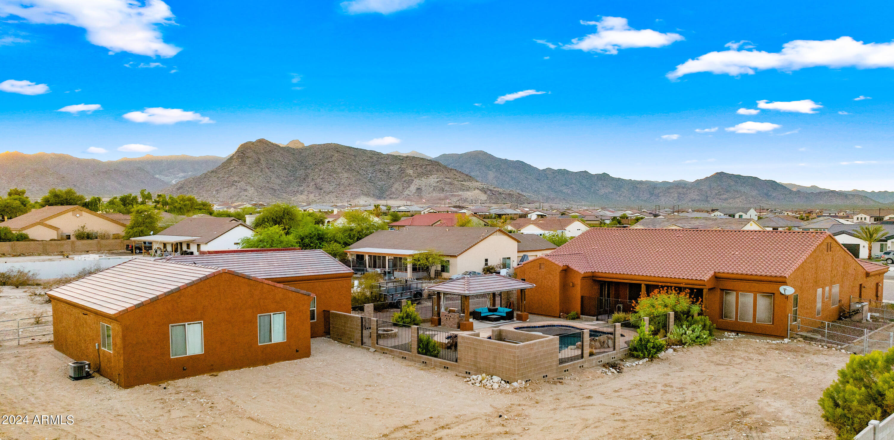 TWO HOMES ON ONE PROPERTY | NO HOA | NEARLY 1 ACRE.  Rare opportunity to own a private Litchfield Park compound featuring TWO SEPARATE RESIDENCES on a fully fenced lot. Includes a 3,051 SF Custom Main Home AND a NEW 2024 High-End 920 SF ADU/Guest House.
The main residence offers 4 beds, 2.5 baths, den, & 14-ft vaulted ceilings. The 2-bed, 1-bath guest house is a modern masterpiece w/ full kitchen, tankless water heater, laundry, & 12-ft high garage (lift-ready!).  Total 5 garage spaces + massive RV/Trailer parking.
Outdoor Oasis: Sparkling pool w/ waterfall, spa, Baja step, & grand gazebo. Perfect for multi-gen living, rental income, or a home studio. An incredible value that cannot be built at this price! This estate offers the ultimate in versatility and privacy.