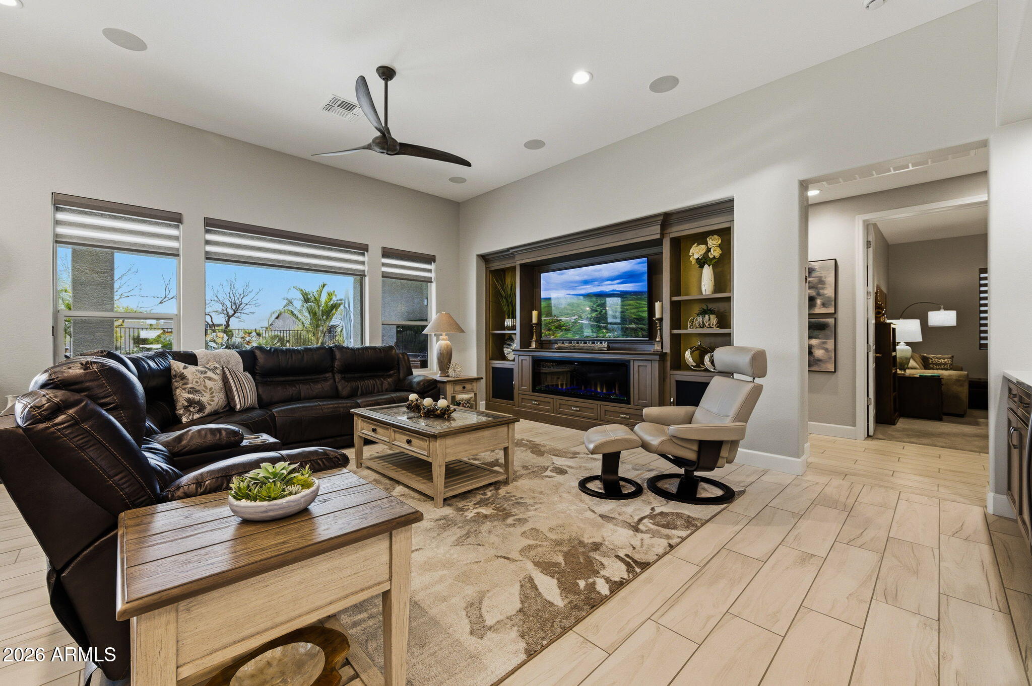 Exceptional ''Vienta'' Model -  OWNER HAS INVESTED $414,887 IN EXTRAS IN THIS HOME!  Offers luxury, comfort, and thoughtful upgrades throughout. The breathtaking kitchen showcases top-of-the-line finishes, gorgeous custom cabinetry with pull-outs in every cabinet, and a versatile microwave that also functions as a second oven. Step outside to a spacious, beautifully landscaped yard backing to a wash for added privacy and serene views. Enjoy year-round relaxation in the Sundance 6-person hot tub, complemented by recently installed patio shades (February) for added comfort. Additional premium features include Fully paid Tesla solar system, Ext 4-foot garage with mini split system and epoxy flooring, Bonus storage shed, custom media wall by Stone Creek with built-in electric fireplace WOW!!! shelving, Built-in bar - perfect for entertaining.  Also included is a Water softener system, Hunter Douglas blinds throughout, Upgraded tinted windows, Laundry room with custom cabinetry and a Gas BBQ hookup.With incredible landscaping in both the front and back yards, this home truly offers everything you've dreamed of and more. See attached lists for additional upgrades and features.