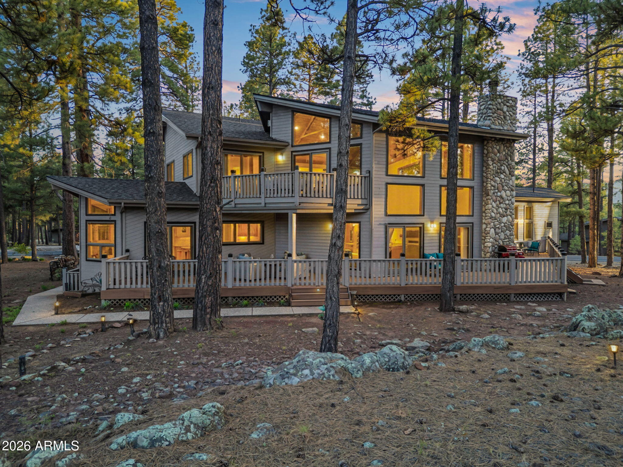 Looking for a house in Flagstaff Forest Highland to move into THIS summer....here it is!   Positioned on the 12th green of the Canyon Golf Course in Forest Highlands, this exceptional, fully furnished, MOVE-IN READY 4,400+ square foot home offers space, flexibility, and strong indoor-outdoor living. Built as a full-time residence and expanded in 2003, the layout is designed for both everyday comfort and entertaining.

The home features 4 large bedroom suites (3 bedrooms on the main level), each with a private bath and oversized walk-in closets--plus extensive storage throughout. Multiple living areas include a spacious great room PLUS Bonus/Game room, PLUS loft, PLUS private office--offering ideal separation for family and guests. The flexible floor plan allows for a primary suite option on EITHER the main level or the second level.  Floor-to-ceiling windows bring in natural light and frame direct golf course views. The open layout connects the main living spaces to a well-equipped kitchen with Dacor and Sub-Zero appliances, gas cooktop, warming oven, wet bar, TONS of cabinets, breakfast nook, VIEWS and a large walk-in pantry.

The primary suite includes a Jacuzzi tub, private deck overlooking the green, and a two-sided gas fireplace shared with the loft.

Outdoor living is exceptional, with over 1,400 square feet of Trex decking thoughtfully positioned to take in sweeping views of the par-3 12th hole of the Award Winning Canyon's Golf Course. Adjacent vacant land offers a rare sense of privacy and openness, creating the feel of a significantly larger estate--with no neighbor on one side.

Additional features include solid wood doors, central vacuum, two 75-gallon water heaters, forced air gas heating, central AC, wood-burning fireplace, ceiling fans throughout, and a dog door.

Additional recent updates include a new roof (October 2025), exterior paint, and updated landscaping.

Set within the prestigious, guard-gated Forest Highlands community--spanning over 1,100 acres of towering pines and natural beauty--residents enjoy access to two award-winning championship golf courses designed by Tom Weiskopf and Jay Morrish. The community offers an exceptional lifestyle with multiple clubhouses, dining venues, tennis, swimming pools, fitness facilities, and an extensive network of scenic hiking and biking trails, all thoughtfully integrated into the surrounding landscape.

This is a rare opportunity to own a spacious golf course home designed for both full-time living and unforgettable summer and winter mountain getaways.  Ready for move in this summer!