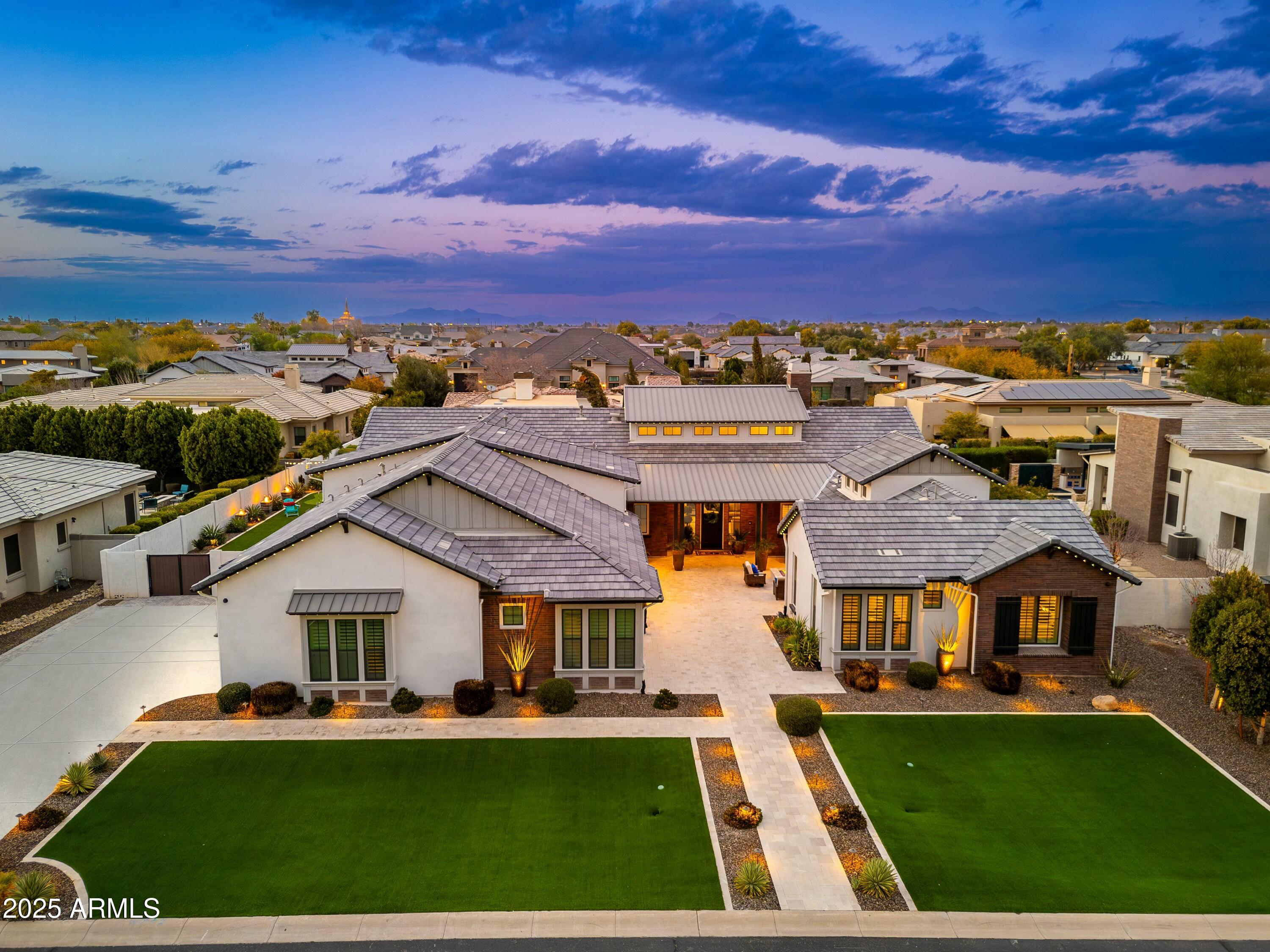 Excellence in prestigious Whitewing at Germann Estates! BASEMENT & CASITA!  Can be purchased w/ most furniture. Luxury meets security in this exclusive Guard Gated Entrance! Elegant iron gates This one-of-a-kind 6,975 sq. ft. dream home, built by Toll Brothers, offers an exceptional blend of elegance, comfort, luxury & ultimate in entertainment. Courtyard entry welcomes you to this amazing 6 Bedrooms,(ALL ENSUITE)  6.5 Bathrooms Estate with a spacious 1,922 sq ft Basement! PLUS guest/ multi-gen Casita=separate entrance, and 4 Car Garage! Grand living & dining room with soaring 20ft ceilings, 3 sleek tiled electric color-changing fireplaces, 16ft wall of glass, and wet bar/ smoothie station. Kitchen is a true Chef's delight-Wolf 60''dual gas range AND double ovens below, steam oven Subzero 36'' Sub Zero Refrigerator and Freezer, plus 30" wine re-fridge w/ pull out beverage drawers, two center islands, HUGE pantry and coffee bar/niche. Gorgeous staggered Alder cabinets with glass front on upper cabinets light. Quartz countertops and Carrera marble herringbone back-splash. Family room boasts custom media wall w/ hidden storage cabinets and 100" electric fireplace, and 16ft disappearing wall of glass. 1200sq. ft. Owner's suite features double-door entry, dual closets, walk-out to private patio, remote window shades,  spacious ensuite with16 ft. ceilings, soaking tub, separate shower and dual vanities. Beautifully designed office features a hidden bookcase door and custom built-in cabinetry and desk, offering a unique and private workspace. The Basement is an entertainer's dream, theater area, game area, custom wet bar, gorgeous granite and cabinetry, full refrigerator, and extensive cabinetry for display, Separate work-out room- Also downstairs are two additional bedrooms and two bathrooms, making it a perfect retreat for guests or extended family. Every inch of this home showcases superior craftsmanship, custom designer additions. Casita is approximately 500 sqt ft, provides a private entrance a living area, kitchenette, bedroom and bathroom perfect for guests or multi-gen living. Incredible Backyard Paradise w/ entertainment options galore! Awesome pebble-tech salt water heated pool with water slide, grotto cave, 20 man hot tub with swim-up bar and custom fire pit, and beautiful water/fire features everywhere !!  WHAT A SUPERB HOME!!