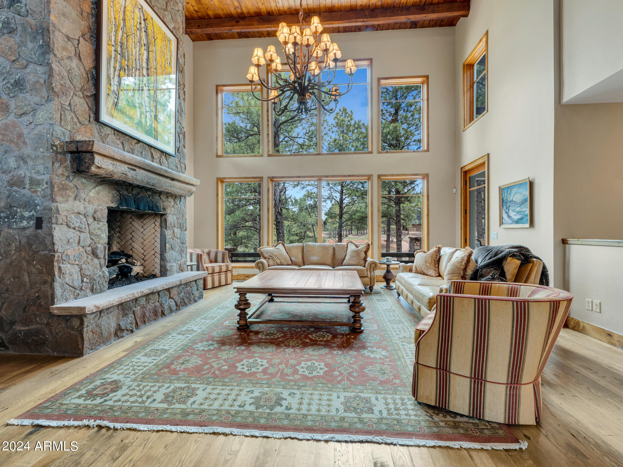 Situated on a secluded cul-de-sac in the heart of Pine Canyon with views of the 17th tee box, 16th green and mountains, this home is a true masterpiece of luxury living. Designed by Otwell Associates Architects, every detail of this lodge-style retreat exudes elegance and sophistication.
As you step through the inviting Foyer, you are immediately captivated by the dramatic Great Room. Rustic reclaimed wood floors, a towering stone fireplace, and bold timbers create a warm and welcoming atmosphere, while the floor-to-ceiling windows offer breathtaking views of the San Francisco Peaks.
With four master suites, 3 of the suites with its own fireplace and all with their own walk-out deck or patio, this home offers comfort and privacy. The loft provides additional spaces for entertaining.  The kitchen features Wolf and Sub-Zero appliances in and ensures that every culinary endeavor is a delight.
From the expansive decks to the finest finishes and fixtures, this home truly embodies the pinnacle of mountain luxury living. Escape the ordinary and embrace the extraordinary in this stunning residence, where every day feels like a vacation.
*Buyer is required to purchase a Membership in either category at Close of Escrow.