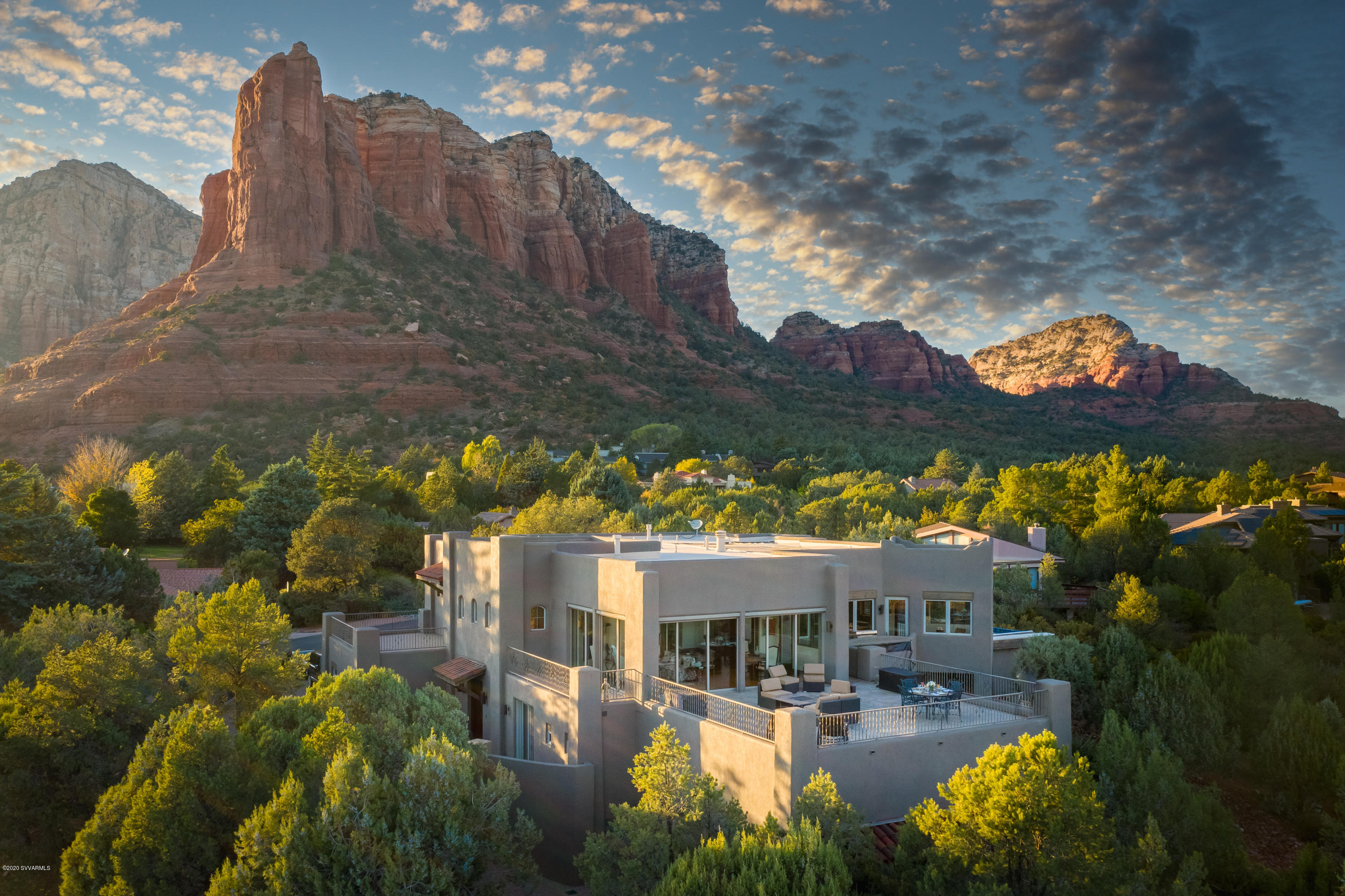 Experience the extraordinary! Sitting proudly at the top of the highly coveted Soldiers Pass Corridor, this luxury home provides million dollar panoramic views. Sliding glass walls of windows allow for integrated indoor/outdoor entertainment, with massive deck area, outdoor kitchen center, and lap pool... The expansive views are complimented by stunning sunrises and sunsets from multiple decks.Exquisite finishes and superior quality of construction including heated countertop bar, Australian cypress and travertine floors, radiant zoned floor heat in addition to zoned forced heat and air, alligator juniper mantels,  large master closet with laundry, library, office/den, theater/ media room, multiple fireplaces, his and her garages, and gourmet chef's kitchen. Special features include elevator, exercise room, spacious guest suite complete with its own full kitchen and laundry; top-of-the-world solar heated lap pool with refreshing, healthy, plain water-no chlorine or salt. It is a pleasure to behold its authenticity and quality.