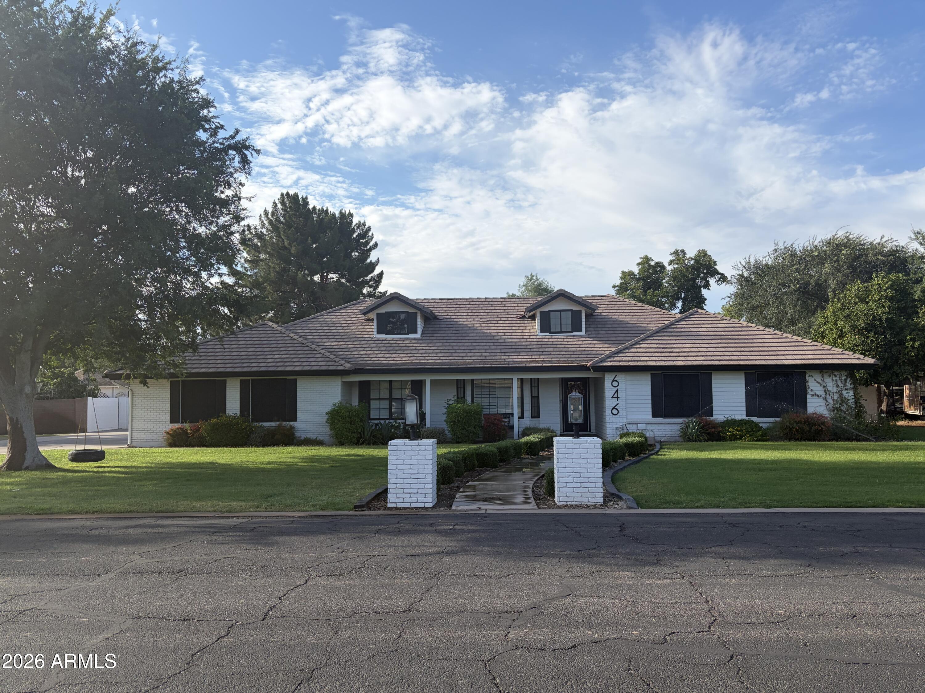 Beautifully remodeled ranch style home on an irrigated farm lot in a highly coveted non-HOA community just 1 mile to Downtown Gilbert.Enjoy the perfect blend of country charm and modern luxury with great curb appeal, inviting front porch, extra long driveway, added detached garage ideal for vehicles, storage, workshop. Backyard offers large covered patio, playground, chicken coops, animal pen.Inside, beautifully remodeled great room and kitchen offer open concept living. Flooring is a neutral engineered hardwood.Kitchen offers 2 oversized islands, quartz countertops, double built-in ovens, abundant cabinetry.Laundry and mud room add to storage.Cozy brick red fireplace anchors the living space.Home offers 2 primary suites, three bedrooms, four full baths, AND basement (with office &storage!