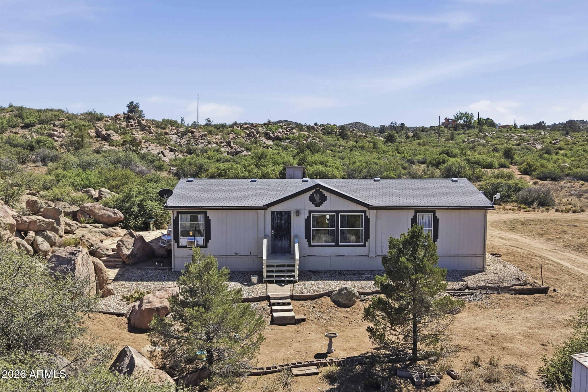This private 10-acre high-desert parcel  offers spectacular panoramic mountain and valley views with a 3bed 2 bath manufactured home, automated hauled water system, and regular updates to the home. This horse property is surrounded by rolling hills and striking natural boulder formations, the land provides complete peace, rural freedom, and excellent investment potential with a zoning allowance for 2-acre minimum splits. Its also fully fenced and about half a mile from pavement with plenty of storage in any of the 4 sheds on the property.