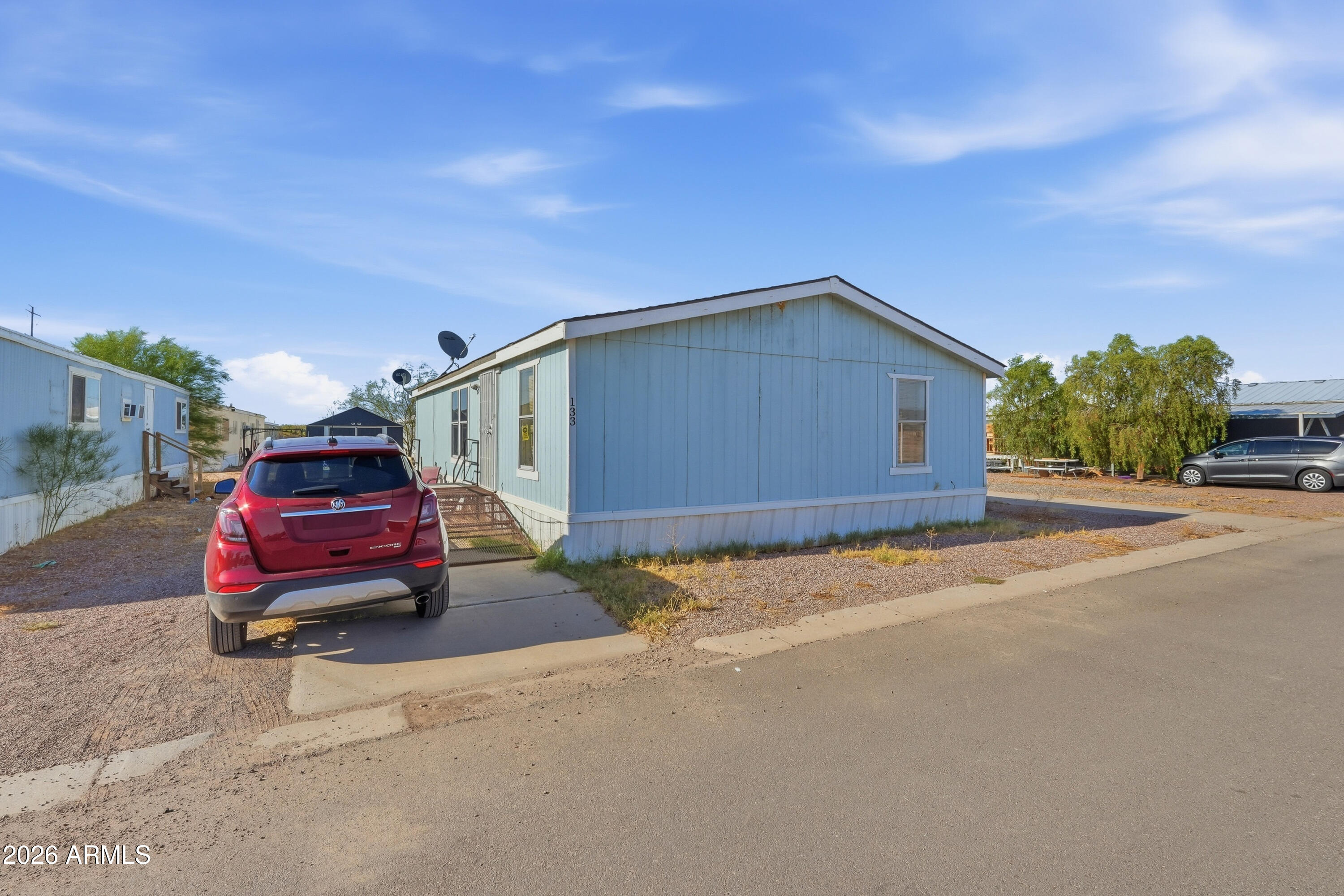 Welcome to this charming manufactured home located on leased land with a monthly lease rent of $580. This well-kept home features 3 bedrooms and 2 bathrooms with a comfortable layout designed for easy living. Inside, you'll find a mix of laminate and carpet flooring, white cabinetry, black and stainless kitchen appliances, and granite countertops that add a stylish touch to the kitchen. The driveway provides convenient parking, while the home's functional floor plan offers comfortable spaces for relaxing, dining, and everyday living. A great opportunity for affordable homeownership with inviting interior finishes and practical features throughout.