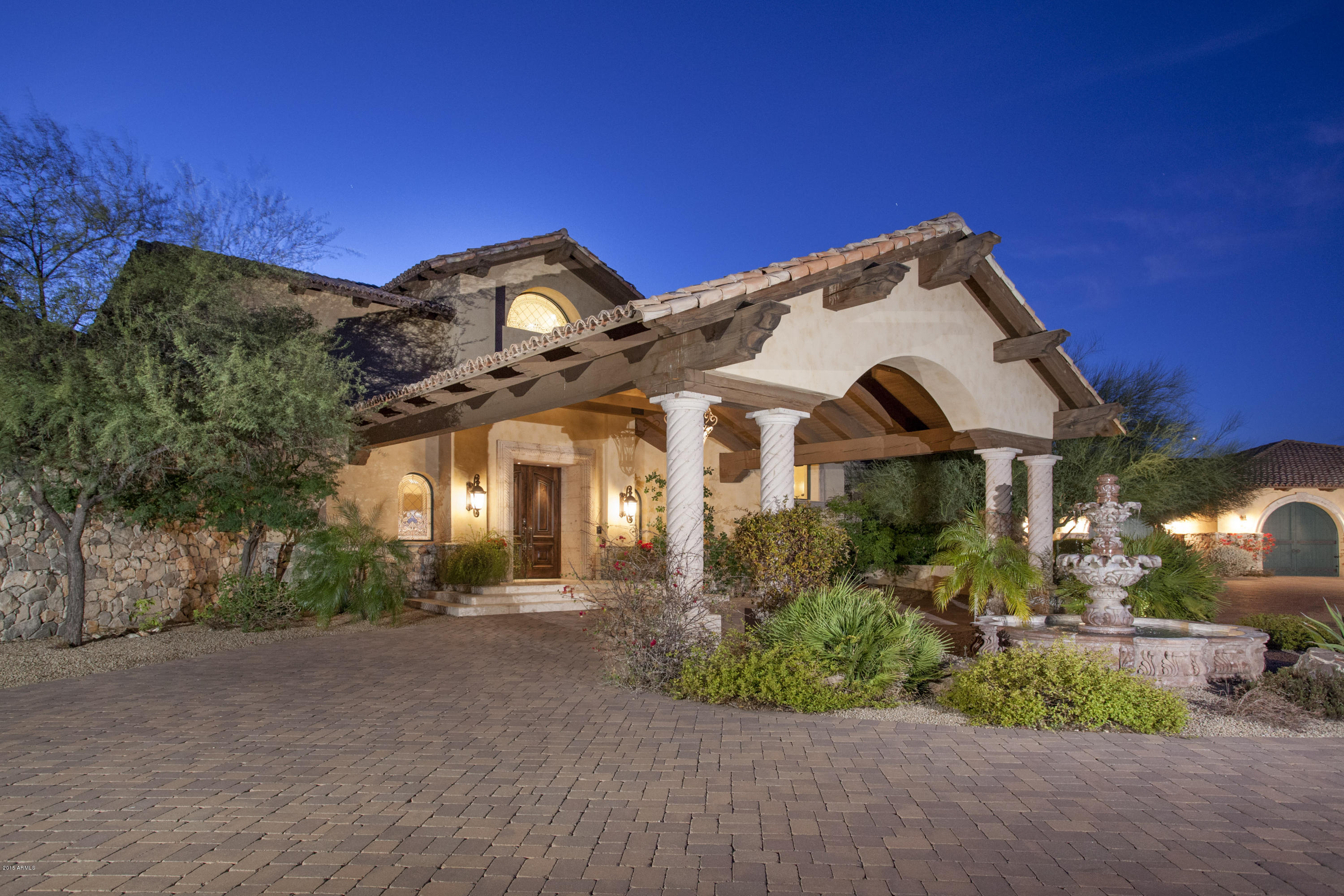 Nestled on 4+ acres of high sonoran desert, this Magnificent Mediterranean Villa awaits. Tranquil & secluded, this superbly crafted residence offers breathtaking views of mountains, dazzling city lights & magical sunsets. Step inside the gracious foyer to soaring ceilings & one of three disappearing glass walls that welcome you to the elegant backyard w/ the city view below. All living is main level (incl. 2nd master), except the spectacular private master suite. Lavish amenities include Control4 Smart System, full bar, theater, wine cellar, butler's pantry, exercise room, elevator, 6 FPs, water/fire features, A/C garage plus a host of fine finishes including stone/cantera details, venetian plaster/artisan accents, hand-forged iron staircase & exquisite ceilings. Finest lot in The Peak.