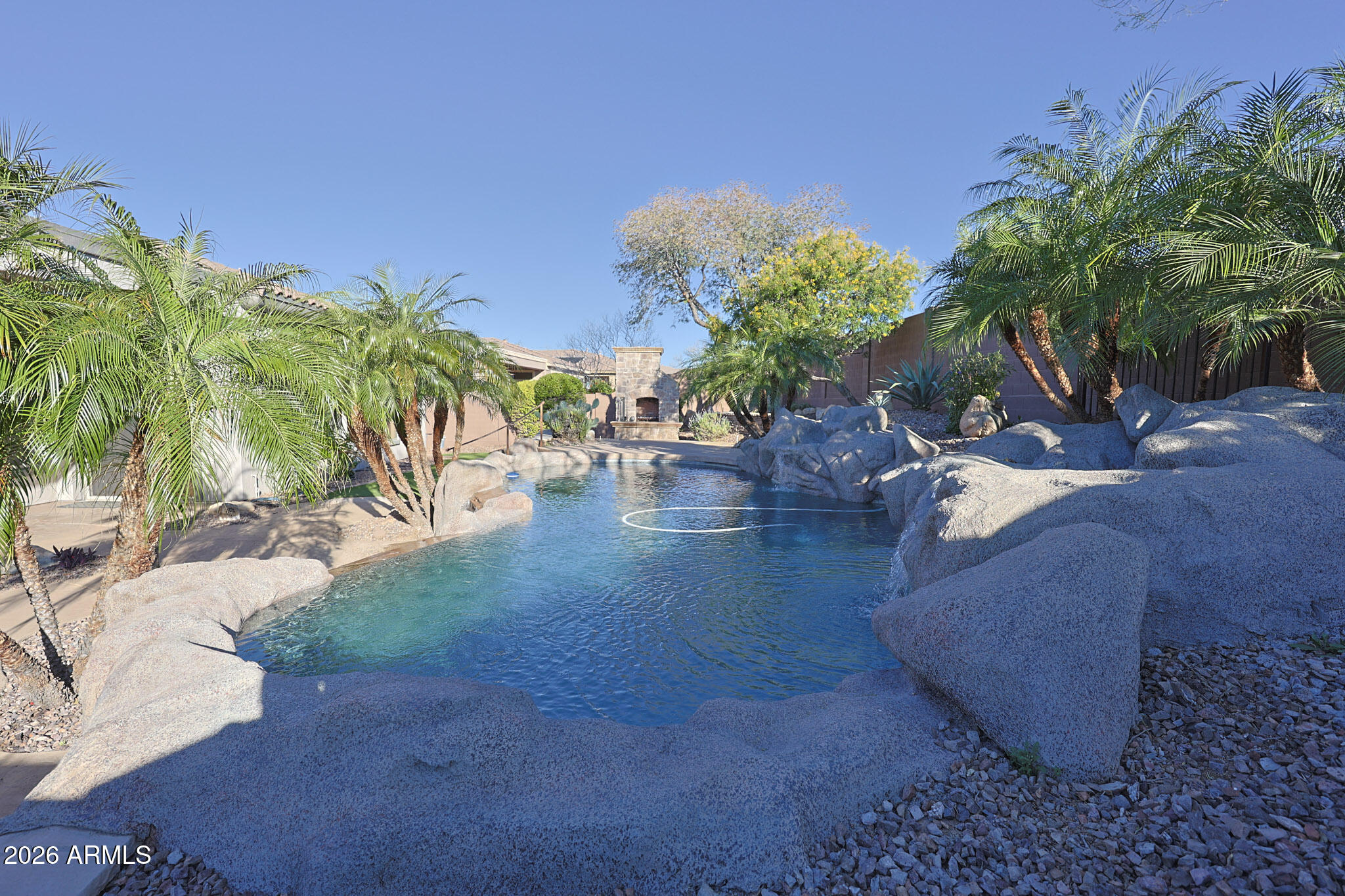 This home features Fresh Interior and Exterior Paint, a private Casita with Full Bathroom, 2 New AC Units, Brand New Carpet, a Remodeled Pool, and a breathtaking Resort Backyard inside a Private Gated Community with 2 Restaurants, 2 18-Hole Golf Courses, Tennis & Pickleball Courts, 2 Swimming Pools & 2 Fitness Centers. 4 total bedrooms with All New Carpet and Fresh Interior and Exterior Paint that make every room feel new. Kitchen includes granite counters, Island with Breakfast Bar, and all appliances included. A Walk-in Shower adds a modern touch. Outside, your Amazing Remodeled Pool anchors a Resort Backyard framed by low-maintenance Synthetic Turf - perfect for Arizona living year-round. The Casita with Full Bath delivers ideal flex space for guests or a private office. Come and Se