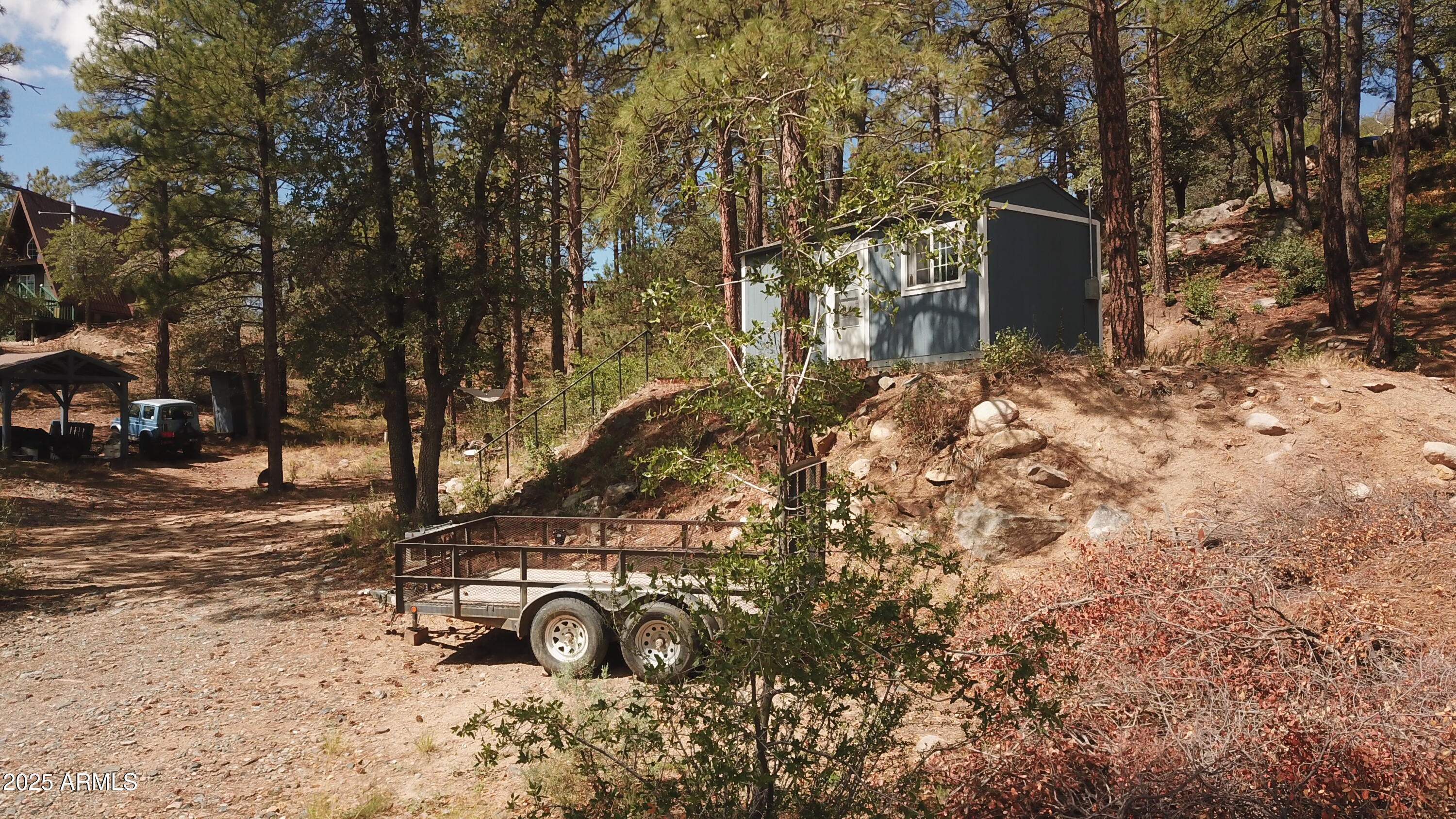 Looking for a premium subdivision lot with great views and easy access? This .57 acre parcel consists of two lots providing a premium building site with TuffShed storage building. This parcel has plenty of level area with access from both Manzanita Rd and Mountain View Rd. Build your custom cabin on this quiet dead end street nestled in the tall pines high above the town of Crown King. The existing structure may not be used as a residence. Here is your prefect opportunity to build your dream cabin.  APS electricity is available. Building will require the installation of a septic system. Come see the opportunities provided by this building site. Enjoy our gentle four seasons at 6,200+ elevation. Nothing compares to Crown King! It's Far From Ordinary!