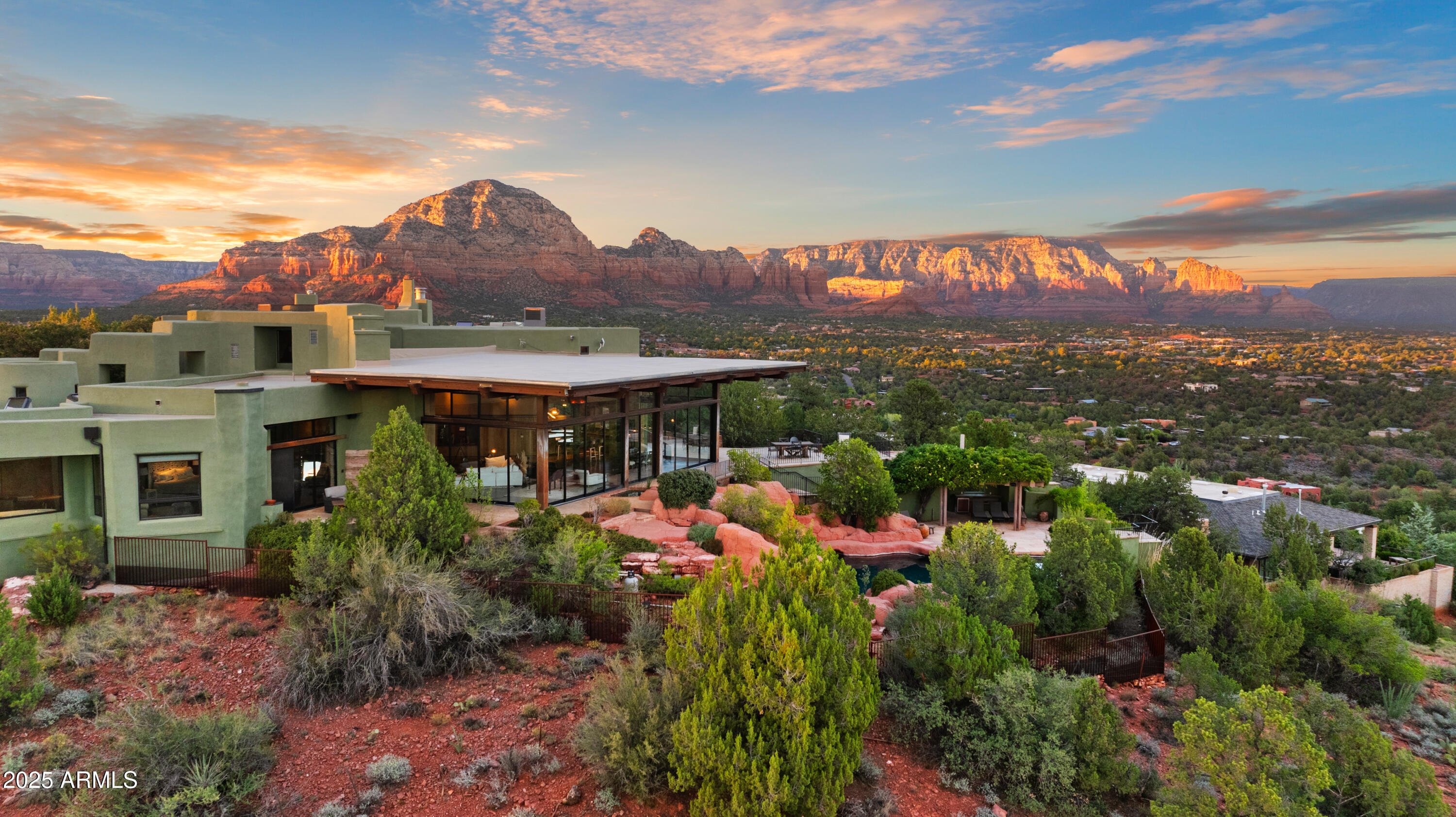 Sedona's Pinnacle of Privacy & Panoramic Beauty: Perched high in one of Sedona's most exclusive gated communities, this Santa Fe styled masterpiece is surrounded by acres of National Forest and offers a level of privacy often sought by those looking to escape. From sunrise to starlight, unobstructed red rock panoramas create a backdrop unlike anywhere else. 

Perfect for intimate living, yet designed for unforgettable entertaining, the home features a seamless indoor-outdoor flow with disappearing glass walls, multiple fireplaces, expansive view decks, and a resort-style pool with waterfall. The gourmet chef's kitchen, wet bar, and formal dining space make hosting effortless, while the main-level primary suite offers its own sanctuary with spa bath, gym, and private patio. Upstairs, two guest suites enjoy private elevator access and their own view terraces. Additional highlights include a dedicated office or fourth bedroom, an oversized steam shower, artisan details inspired by Native American pueblo architecture, and an extended 3-car garage for extra cars or room for your hobbies.

In a location second to none, this is more than a home, it's a Sedona experience of unmatched beauty and tranquility.