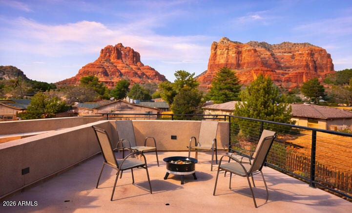 2023 custom Sedona home with breathtaking red rock views from a private rooftop deck in the Village of Oak Creek. Single-level 3BR/2.5BA modern ranch with solar, chef-inspired kitchen, surround sound, covered patio and fenced yard. Close to golf, hiking & biking trails and fine dining, this 2,486 sq ft home features a bright open-concept great room with linear fireplace. The chef's kitchen includes custom cabinetry, granite countertops, stainless appliances and a large island with seating. Energy-efficient solar helps reduce utility costs. Oversized 2-car garage with epoxy flooring and built-in overhead storage racks. Mechanical window blinds enhance comfort and privacy. A rare opportunity to own the builder's personal residence, designed for comfort, efficiency and iconic red rock living. Experience modern Sedona living in this beautifully crafted 2023 custom ranch-style home, designed and built as the builder's own residence with exceptional attention to quality, efficiency, and detail. Located in the highly desirable Village of Oak Creek, this thoughtfully designed single-level home offers 2,486 square feet, featuring 3 bedrooms, 2.5 bathrooms, and breathtaking red rock views from a private rooftop deck.

The open-concept design creates a seamless flow between the living, dining, and kitchen spaces, with expansive windows bringing in natural light and framing Sedona's iconic landscape. The spacious great room features a sleek linear fireplace and a built-in surround sound system, with speakers integrated into the ceiling throughout the home for an immersive audio experience.

At the center of the home is a stunning chef-inspired kitchen featuring custom cabinetry, premium granite countertops, stainless steel appliances, and a large center island with seating, perfect for entertaining or casual dining.

The thoughtfully designed layout offers a spacious primary suite along with two comfortable guest bedrooms, creating an ideal setting for hosting family and friends while maintaining privacy.

Outdoor living is a highlight of the property. The covered patio and fenced yard provide a private setting for relaxing or entertaining, while the rooftop deck captures spectacular panoramic red rock views, offering the perfect place for sunrise coffee, sunset gatherings, and stargazing under Sedona's famous dark skies.

Efficiency and sustainability were incorporated into the home's design with a solar energy system, helping reduce energy costs while supporting environmentally conscious living.

The oversized 2-car garage includes durable epoxy flooring and built-in overhead storage racks, maximizing storage while keeping the space clean and organized.

Additional highlights include:

" Built in 2023
" 2,486 sq ft single-level modern ranch-style home
" 3 bedrooms | 2.5 bathrooms
" Builder's own custom residence with many upgrades
" Built-in ceiling surround sound system
" Modern great room with linear fireplace
" Chef's kitchen with granite countertops and oversized island
" Solar energy system
" Rooftop deck with panoramic red rock views
" Covered patio and fenced yard
" Epoxy garage floor with overhead storage racks
" Located in the Village of Oak Creek, near golf, hiking trails, restaurants, and shopping

This exceptional property offers a rare opportunity to own a newer custom Sedona home designed for comfort, efficiency, and unforgettable red rock living.