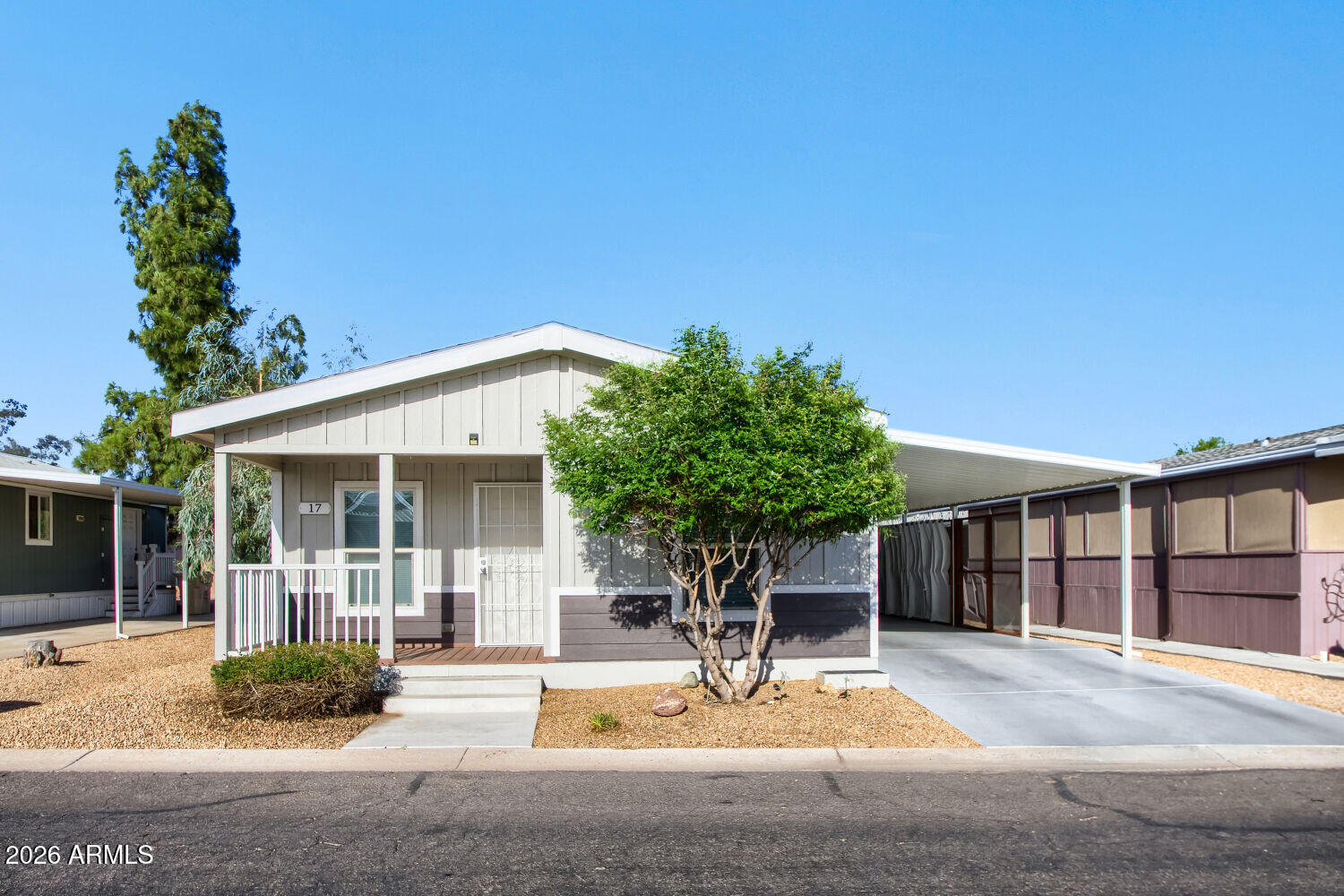 Enjoy low-maintenance living in the gated 55+ community of Casa Del Sol! This beautifully maintained home features modern flooring, a neutral color palette, and a functional layout designed for comfort. The charming kitchen offers ample cabinetry and workspace, while the spacious primary suite includes a large walk-in closet and private bath. The extended carport has been transformed into a shaded patio with sunshades, curtains creating the perfect outdoor retreat. Community amenities include a clubhouse, fitness center, swimming pool, putting green, billiard room, RV parking, and a variety of planned social activities. Don't miss this opportunity to enjoy resort-style living in a welcoming community!