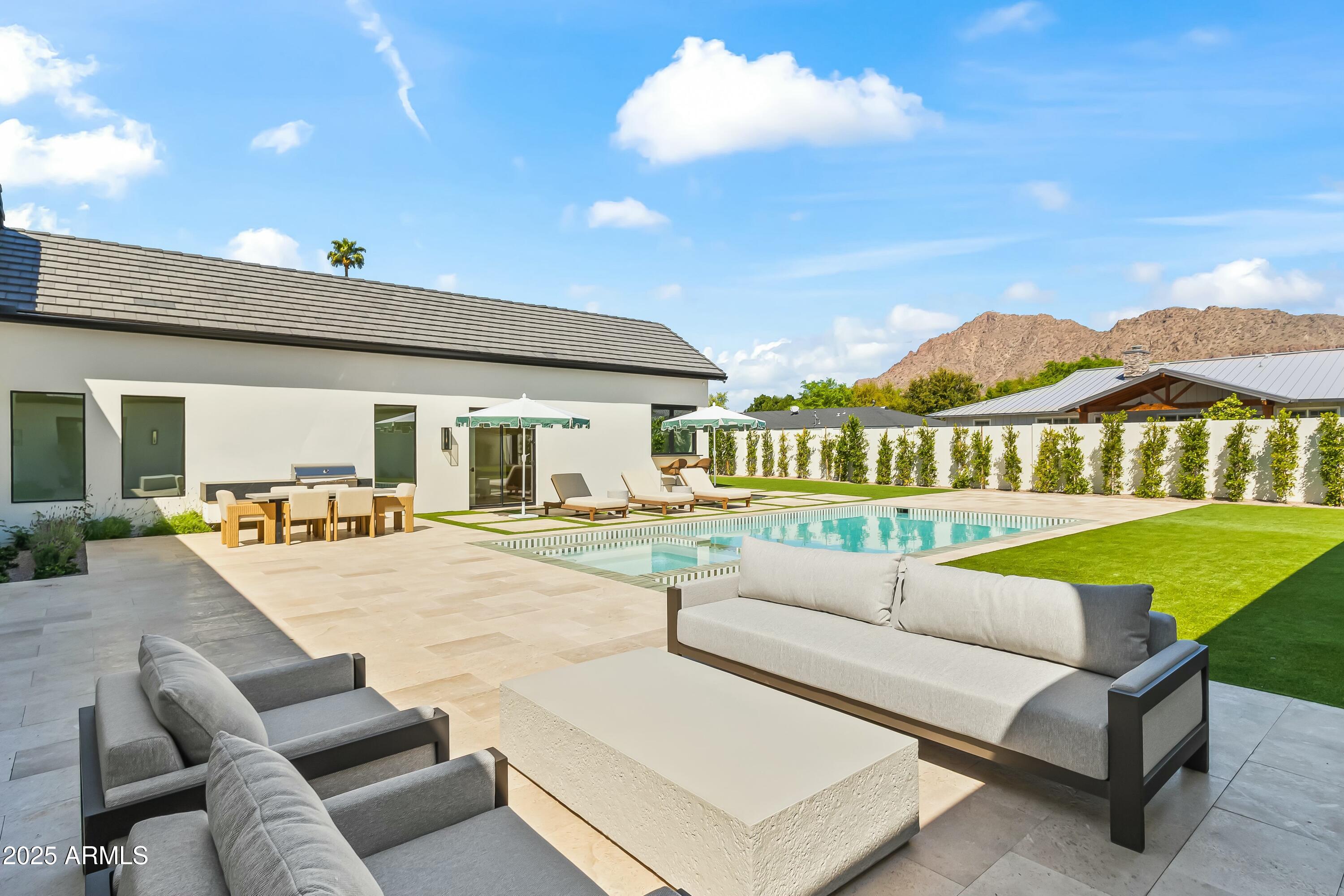 Custom Arcadia Proper new build sitting on a north facing corner lot with stunning Camelback mountain views. No expense was spared on this high end, fully furnished estate designed by Evon Fig Interiors. 

A Fig House Project Built to perfection with rich colors, earthy marbles, Roman clay walls, Waterstone plumbing, Kelly Wearstler wallpaper, and elusive finishes not even found in 20 million-dollar homes. Greeted with high ceilings, French oak flooring, and large windows and sliding doors to provide natural lighting in the formal dining, great room with gas fireplace, and kitchen. Wolf and Sub-Zero appliances included in the chef's kitchen with Calacatta marble, rift sewn oak cabinets, Shaw sinks and catering kitchen/pantry with beverage drawers, built-in coffee maker, microwave, and dishwasher. Primary suite includes custom marble fireplace mantle, dual closets, sinks, and enclosed toilets, concrete tub, and oversized walk-in shower. Entertain family and friends in the backyard's pool and spa with attached pool bungalow, built-in BBQ station, and private mountain views and artificial turf. Additional home features include Control4 Smart Home to control lighting, pool, and landscaping, dog run and doggy door, 3-car garage with EV charger, office/den, and 4 additional ensuite bedrooms with walk-in closets. Walk or bike on the canal or drive minutes to reach Phoenix's top resorts, golf, hiking, dining, and shopping.