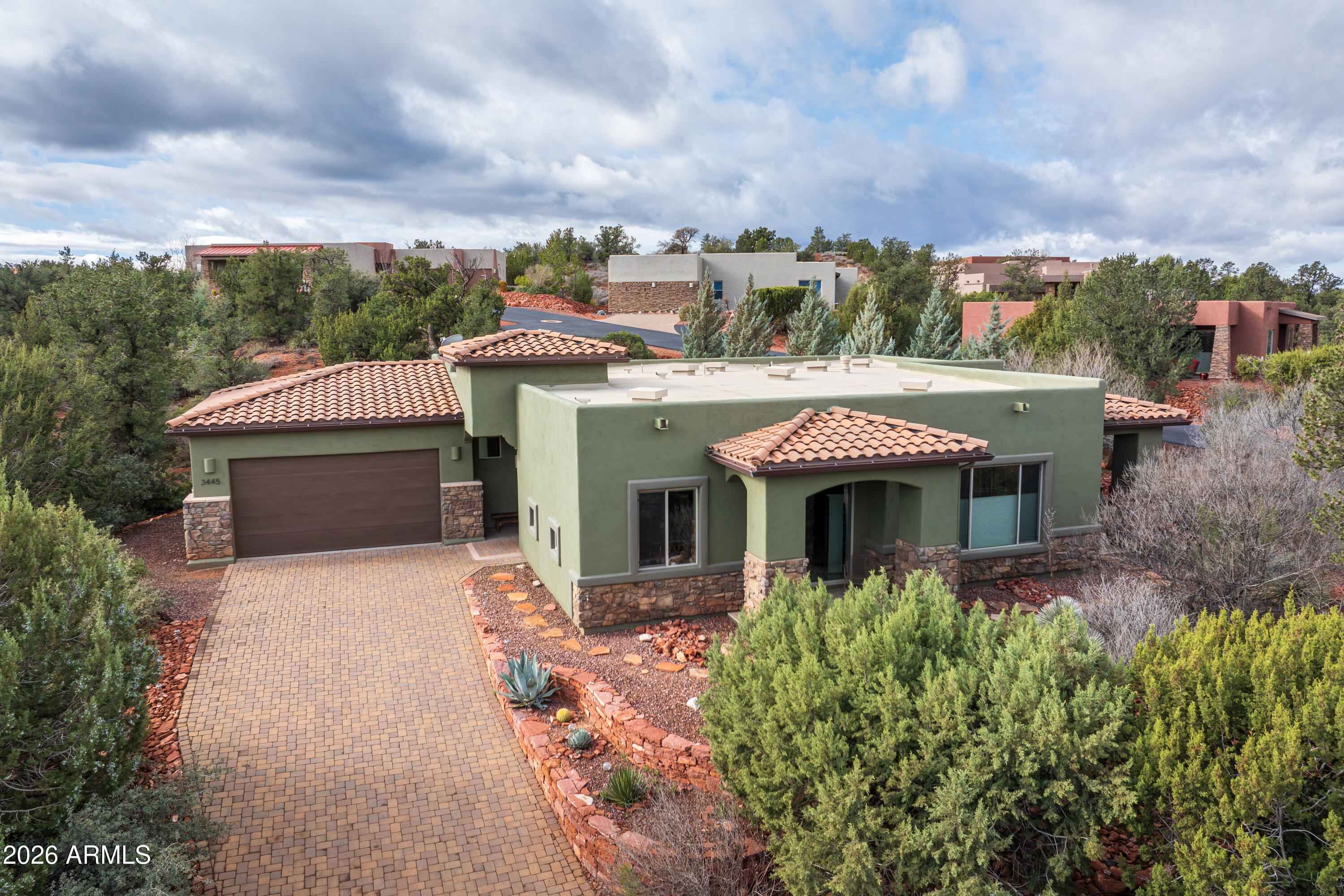 Beautifully located in one of the most desirable & convenient locations in Sedona; this well cared for, move in ready home has 2 en-suite bedrooms plus office/studio (could be a 3rd bedroom), a powder room and 2249 square feet of modern living. Beautiful northern red rock views from dining, kitchen, living room & primary bedroom. Step outside and you'll find two private covered patios also with red rock views. Custom window coverings throughout. Situated on a high ridge with professional landscaping designed for maximum privacy. Attached two car garage with tons of storage space. High efficiency HVAC & Nest thermostat help keep the electric bills low. This is a great opportunity for someone looking for a well maintained West Sedona home with big views and exceptional privacy. This home is located close to all of Sedona's amenities and some of the best hiking trails. The Sedona Medical Center is just up the street; Sedona Red Rock High School & Yavapai Community College are within a mile; and the new Western Gateway trail system is less than a mile away. Also note that this is a single level home with no steps. Come take a look. This may be your opportunity to find your Sedona dream home.