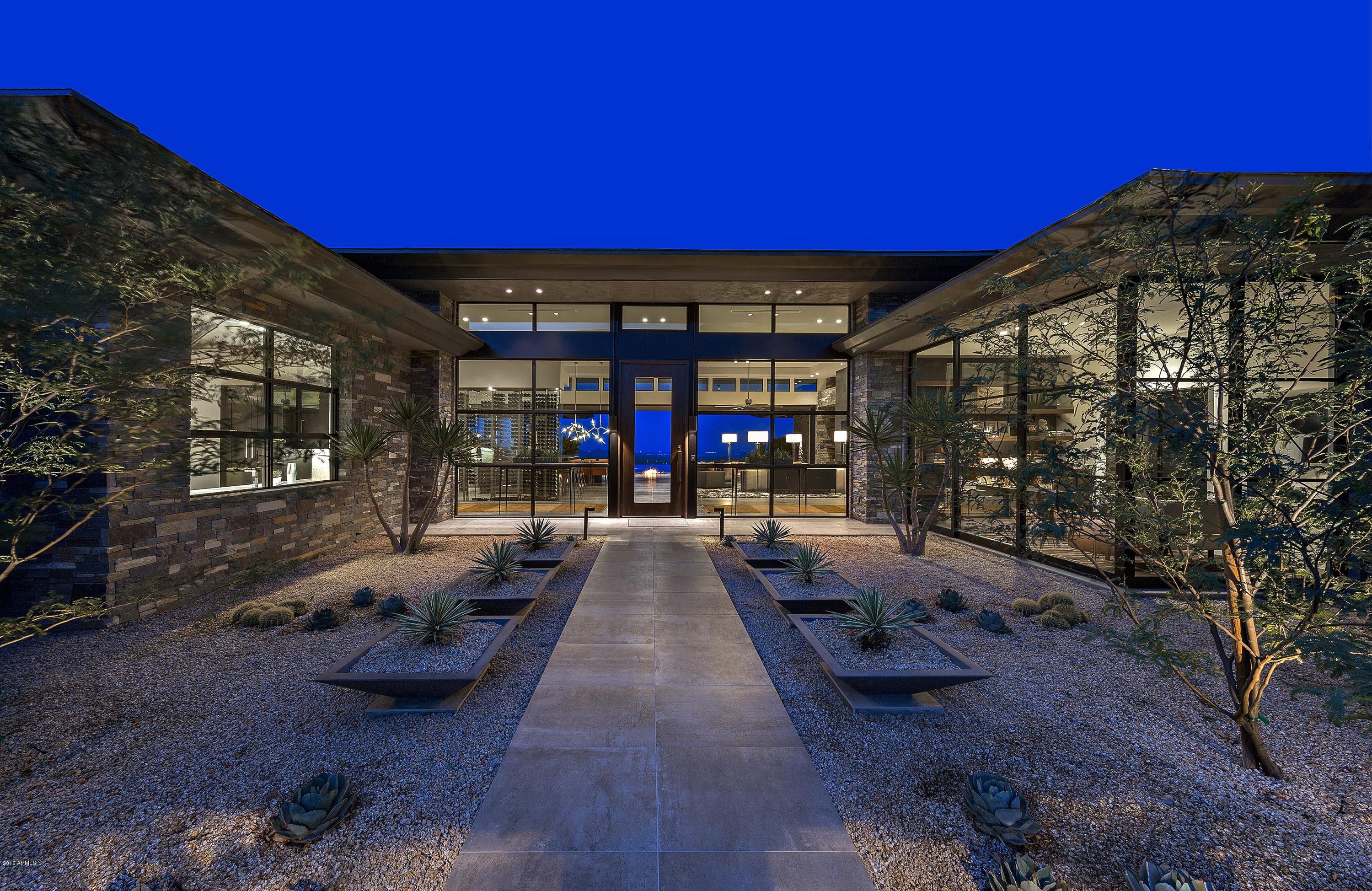 STUNNING CONTEMPORARY SHOWPIECE nestled in its own private reserve in Desert Mountain's prestigious ''Canyon'' neighborhood. Leisure living at its finest in this breathtaking Desert & Golf Paradise. Disappearing glass walls open from the Great Room, sensational Master Retreat and year-round Lanai onto a resort patio that includes a 25 meter infinity lap pool, wall of rain & linear fire pit. Dramatic rock hearth wall in Great Room, Modern Chef's Kitchen and soaring glass Wine Wall & Bar.  Dramatic floating staircase - w/ 22ft window and crystal pendants- with a backdrop of Sonoran Desert views. Exception guest accommodations*Today's Decor*Solar Panels*Elevator*Radiant Floors*4 Car Garage*Control 4 Smart House*Audio/Video throughout incl. Click ''documents'' tab for amenities list.