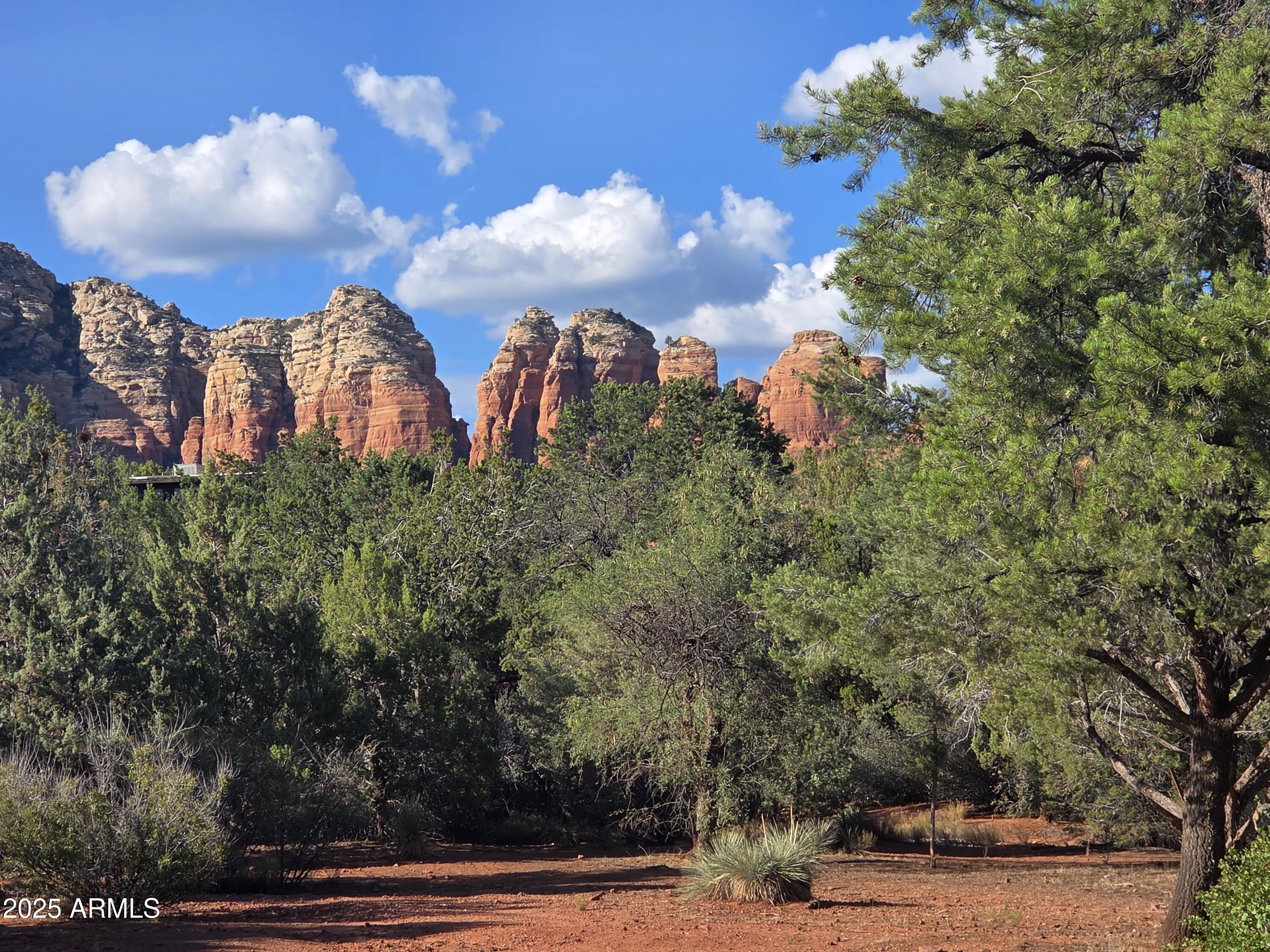 Large, nearly 1/2 acre lot in West Sedona. Privacy, trees, and excellent views. Plenty of room for a primary residence and guest house. Ten minutes from four grocery stores, pharmacies, five banks, medical, and at least 20 restaurants.